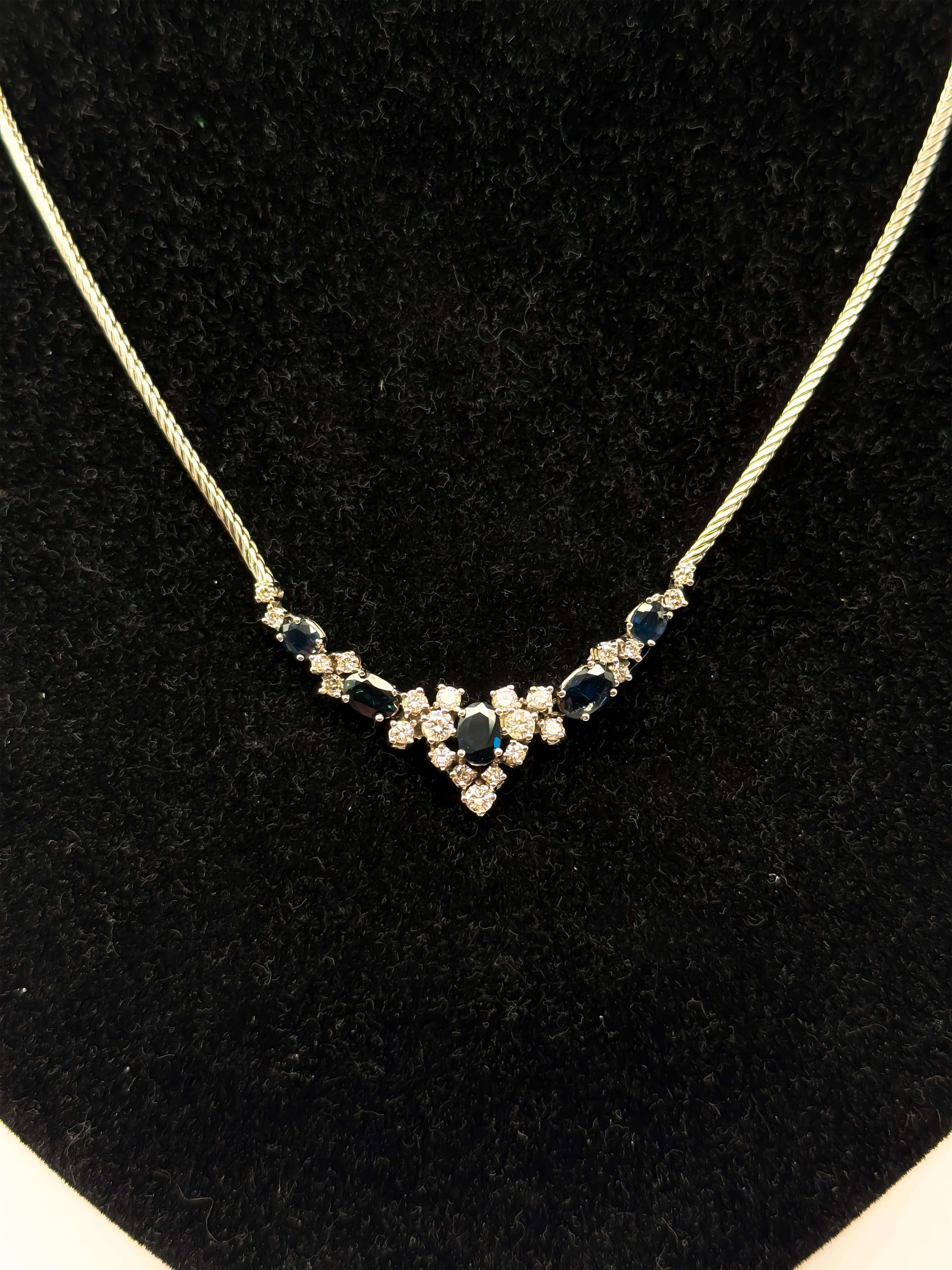 This exceptional pendant crafted from 14-karat white gold combines timeless elegance with vibrant color intensity, making it a standout piece in any jewelry collection. The stylish necklace features a captivating arrangement of natural sapphires: a