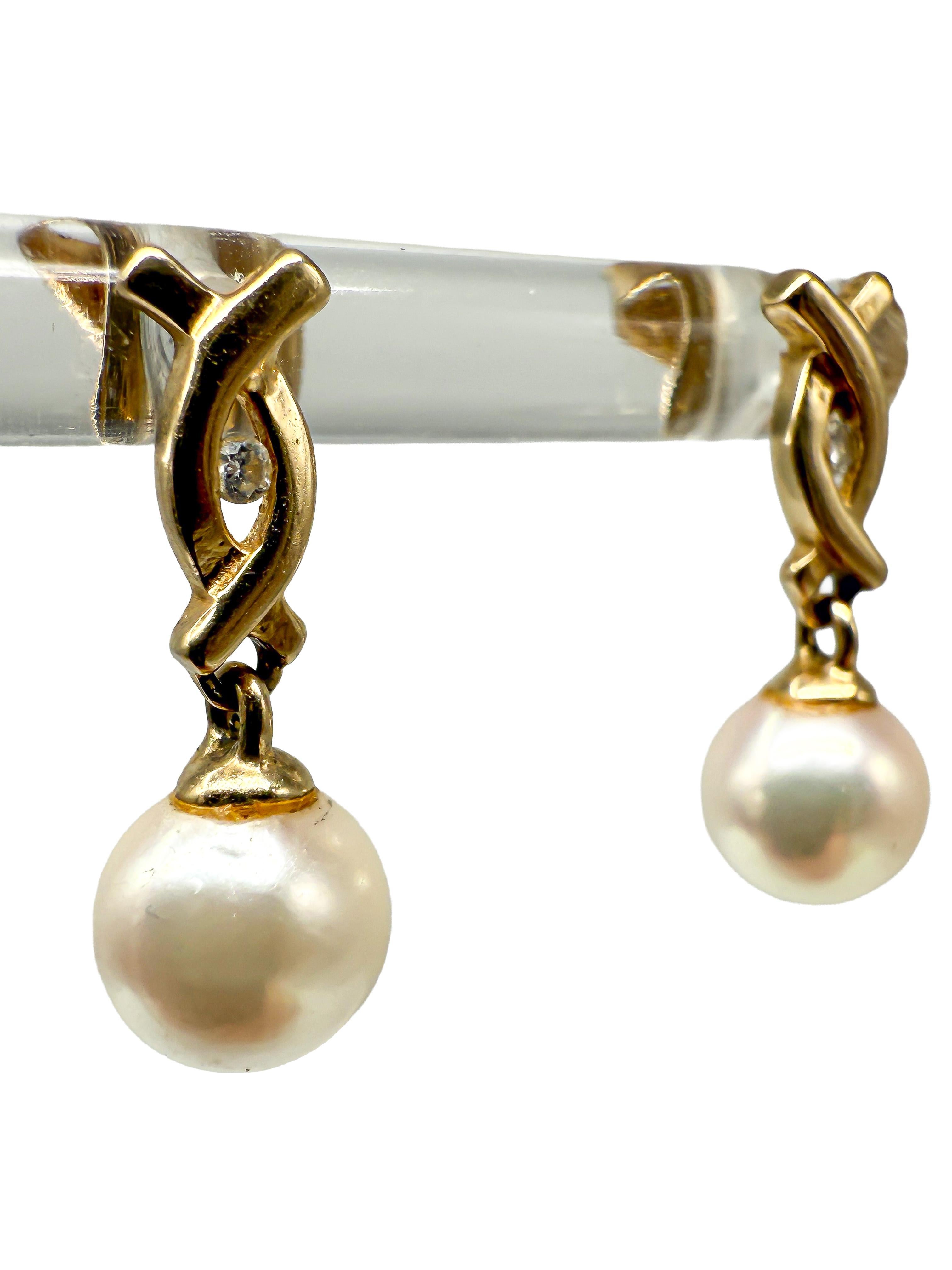 These elegant 14K yellow gold earrings combine classic design with subtle sparkle. Crafted from 14K yellow gold, they feature natural pearls accented with small diamonds, creating a refined and timeless look suitable for both everyday wear and