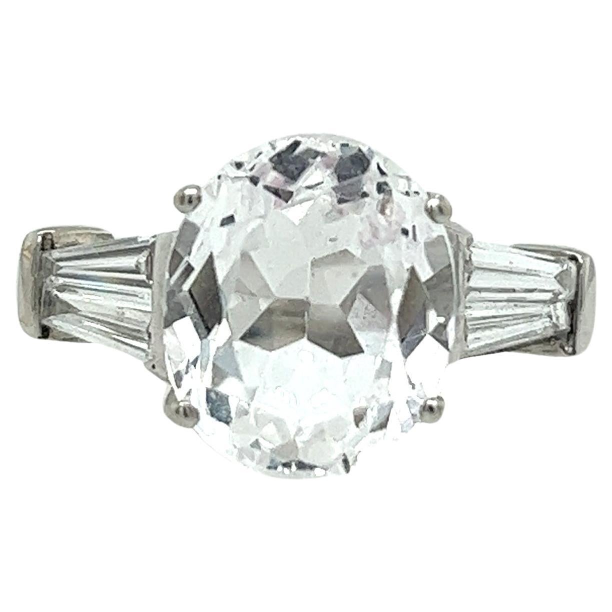 5.85ct Oval Faceted White Topaz Ring with Tapered Baguettes in 18ct White Gold For Sale