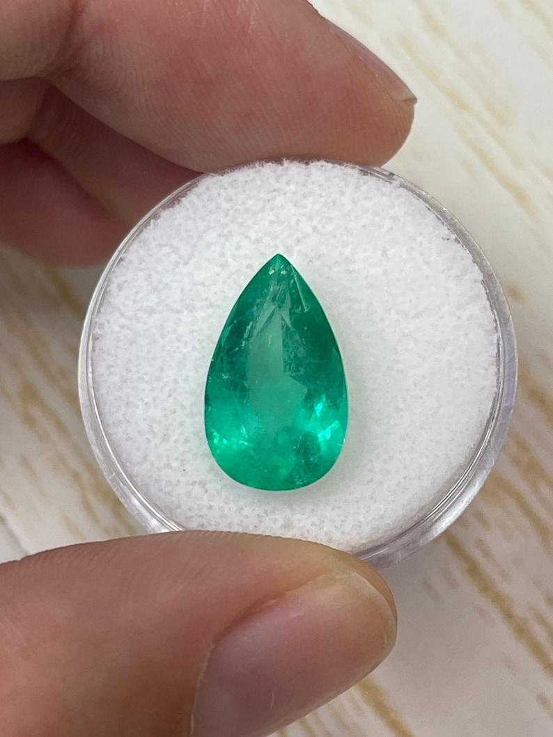 Stone: Emerald
Weight: 5.86-carats
Shape: Pear Cut
Clarity: Transparent
Luster: Very Good
Color: Medium Yellowish Green
Measurements: 15.50mm x 9.47mm x 7.08mm
Geographic Origin: Colombia
Treatment: Natural, Oiling

Comments: Due to their growth