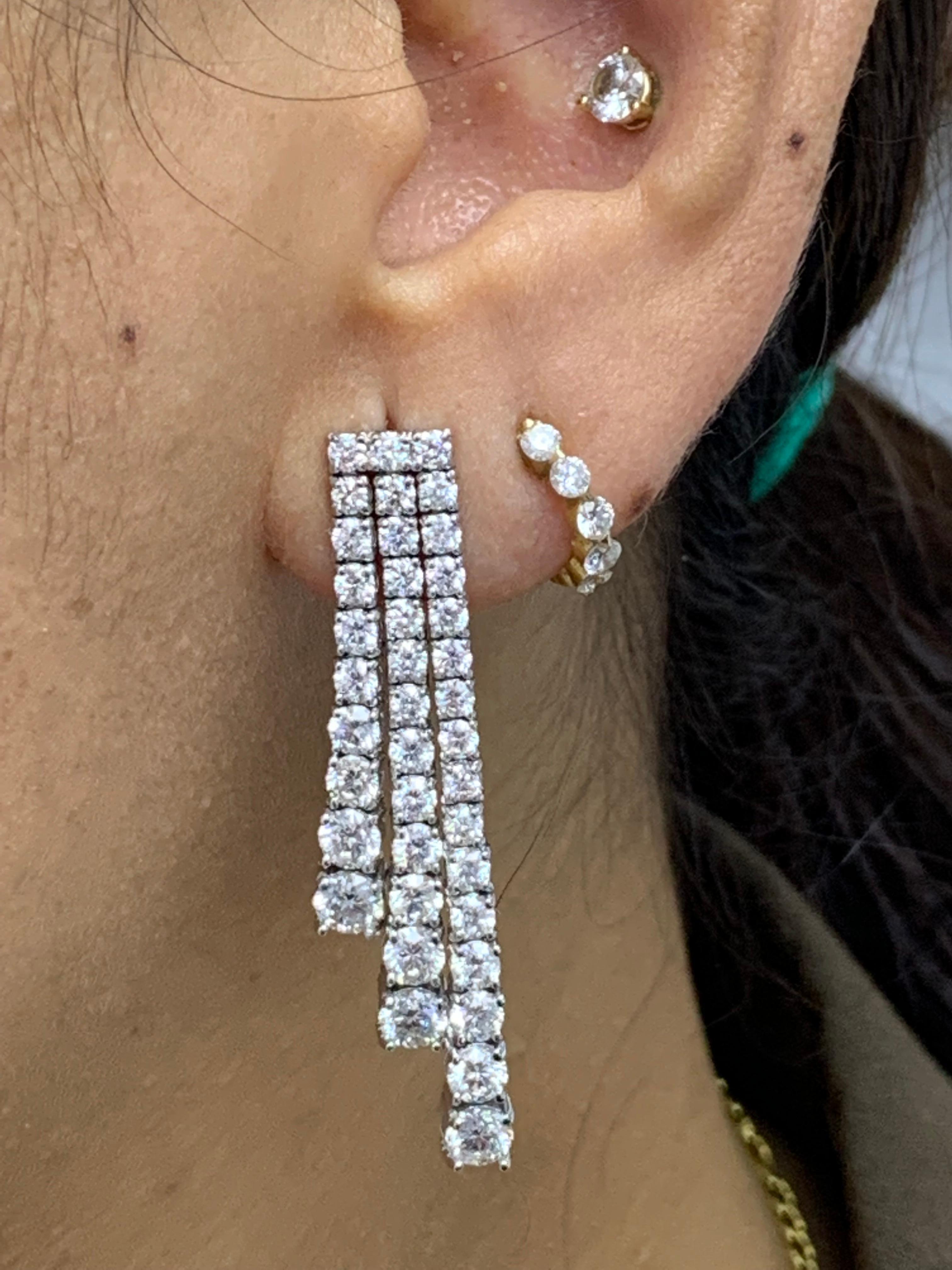 An important pair of dangle earrings showcasing three rows of 5.86 carat round brilliant diamonds. 

Style available in different price ranges. Prices are based on your selection of the 4C’s (Carat, Color, Clarity, Cut). Please contact us for more