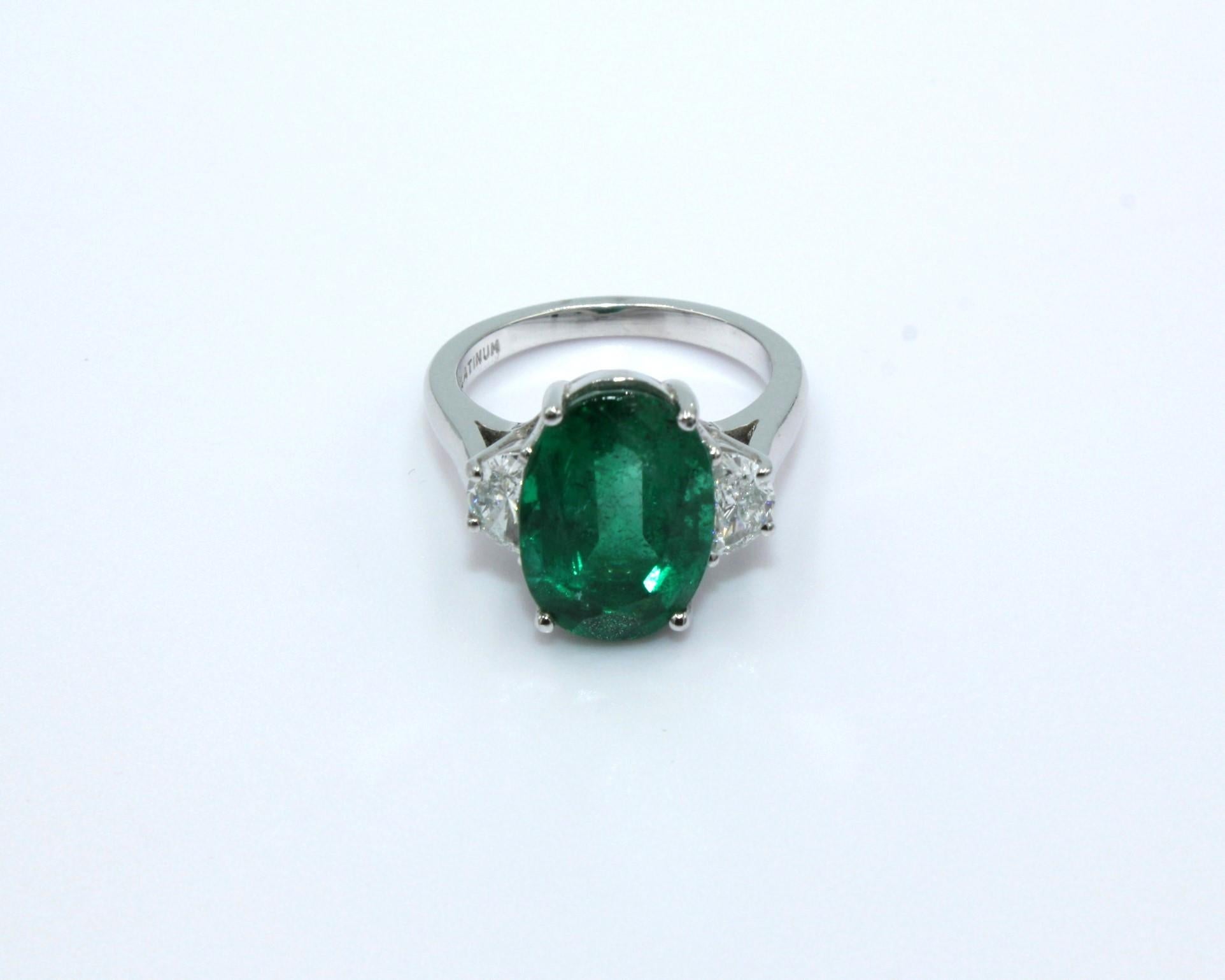 5.86 carats Oval Zambian Emerald with two Half-moon diamonds on both sides, totaling a diamond weight of 0.72 carat. 

This stunning Emerald Diamond Ring will highlight your elegance and uniqueness. 

Item Details:
- Type: Ring
- Metal: Platinum
-