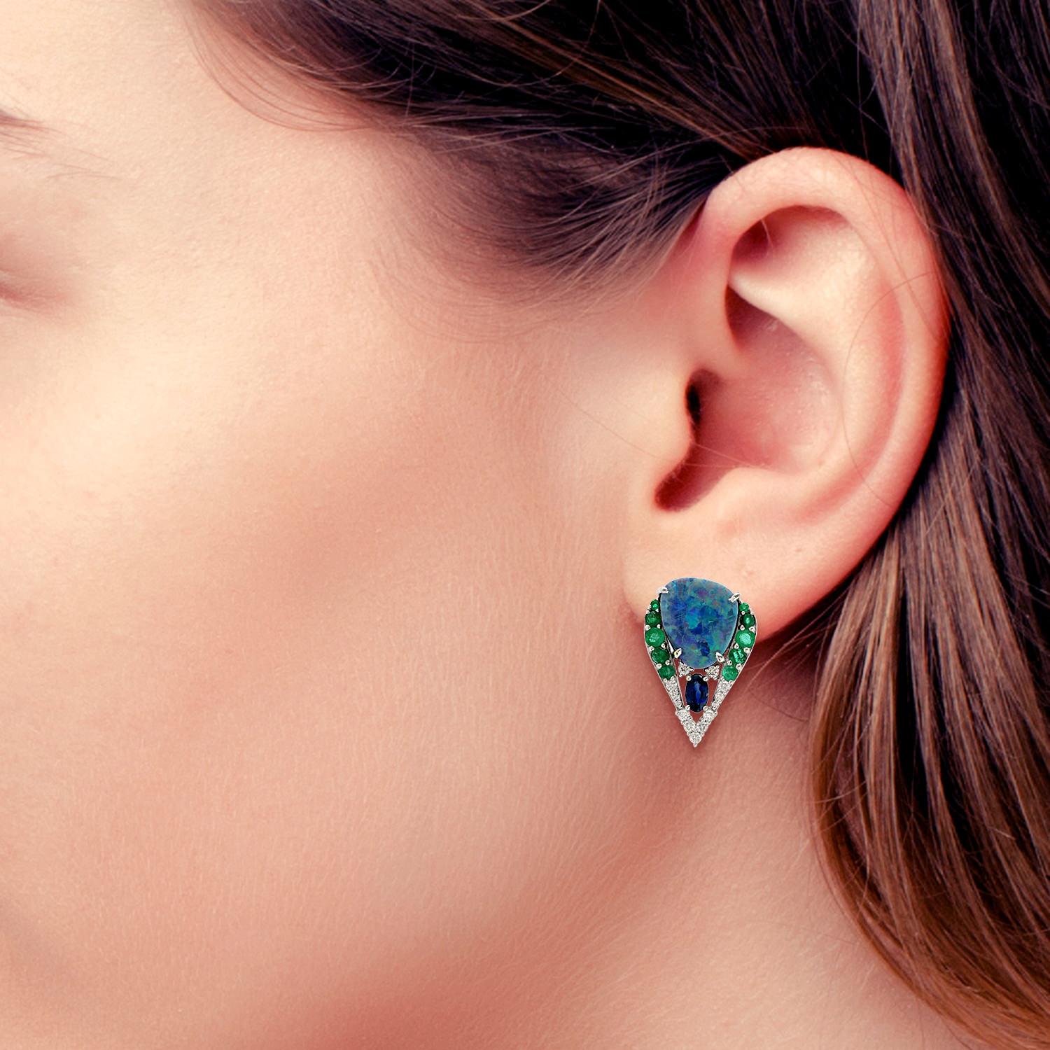 Cast from 18-karat gold, these beautiful stud earrings are hand set with 5.86 carats Opal, .74 carats emerald, blue sapphire and .33 carats of glimmering diamonds. 

FOLLOW  MEGHNA JEWELS storefront to view the latest collection & exclusive pieces. 
