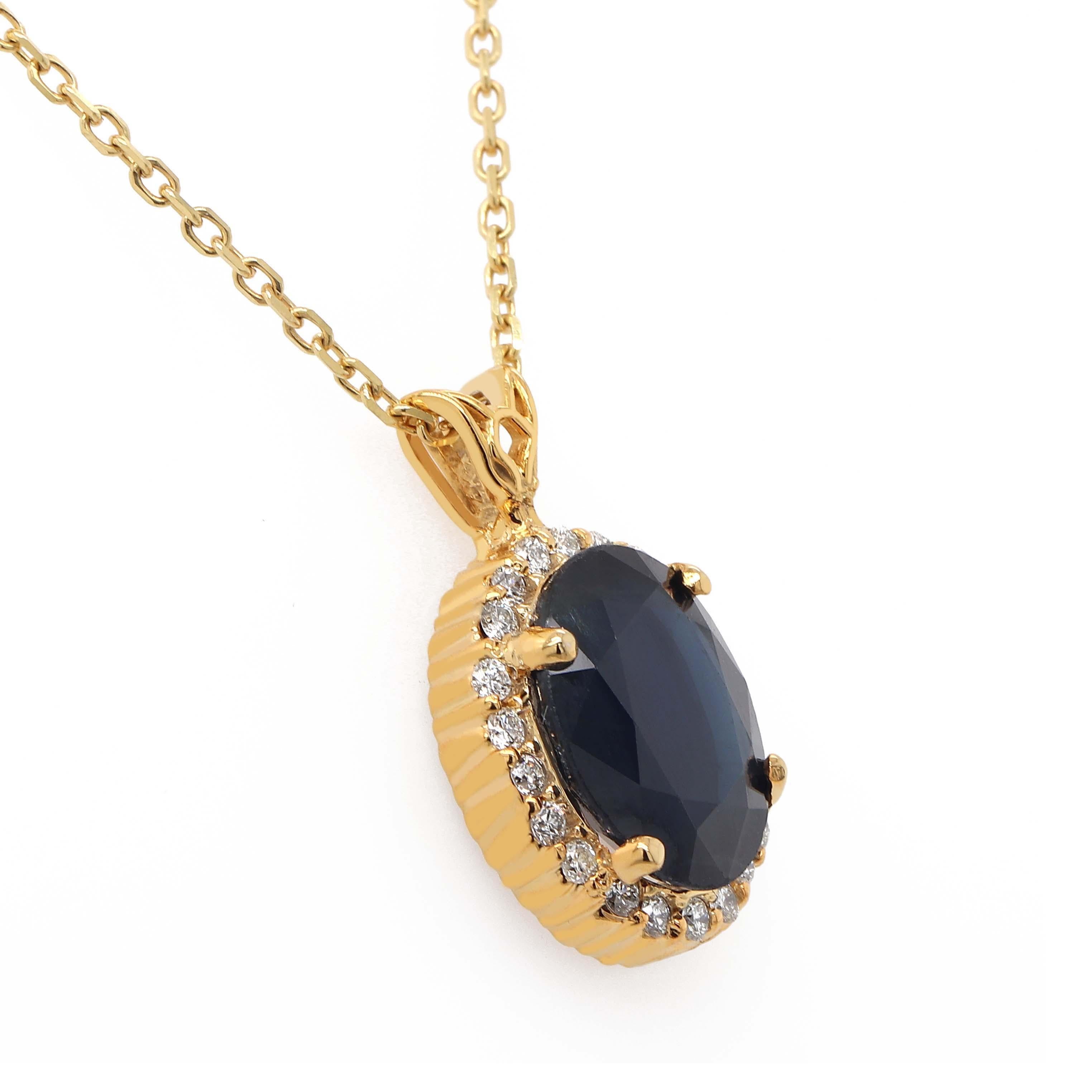 Pendant with one blue oval sapphire of about 5.86 carats surrounded by 22 round brilliant cut diamonds of about 0.39 carats with a clarity of VS and color G. All stones are sset in a 14k yellow gold pendant. Total weight of the pendant is