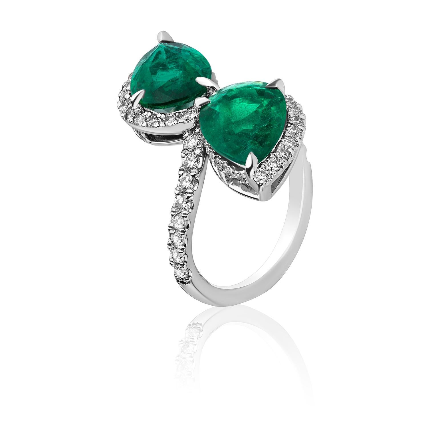 Beautiful Two-Stone Ring comprised of 2 perfectly matched Pear Shaped Emeralds weighing 4.91 Carats and surrounded by 60 Brilliant Round Diamonds weighing 0.95 Carats.

Set in Platinum. Size 6.