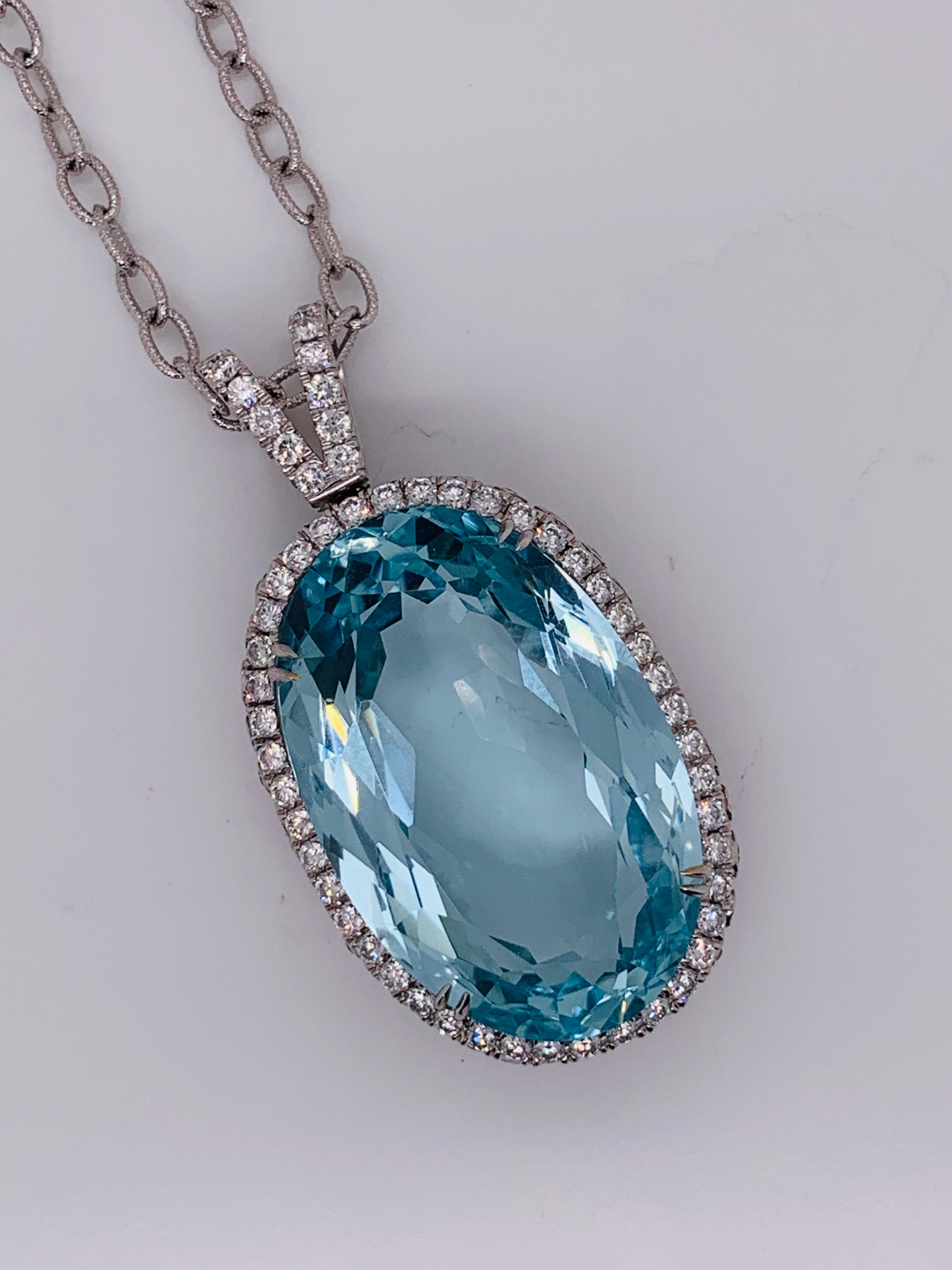 Aquamarine diamond pendant necklace features 58.67 Carats Aquamarine surrounded by 3.00 carats of diamonds in 18K white gold. 
