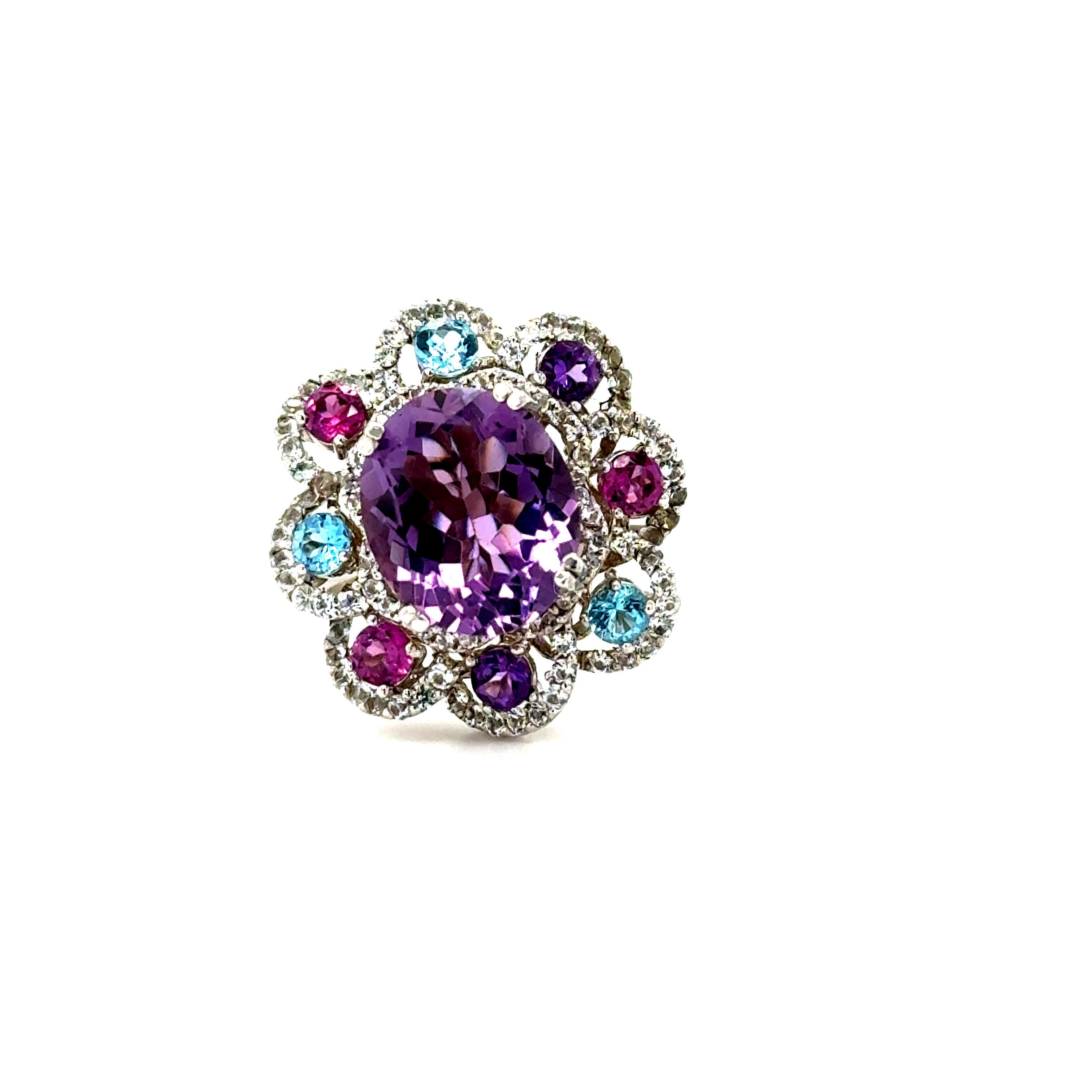 5.87 Carat Amethyst Sapphire and Topaz White Gold Cocktail Ring

This beautiful ring has a Oval Cut 3.79 carat Amethyst that measures at approximately 10 mm x 12 mm. There are Blue Topaz, Garnet, Amethysts surrounding the ring that weigh 0.98