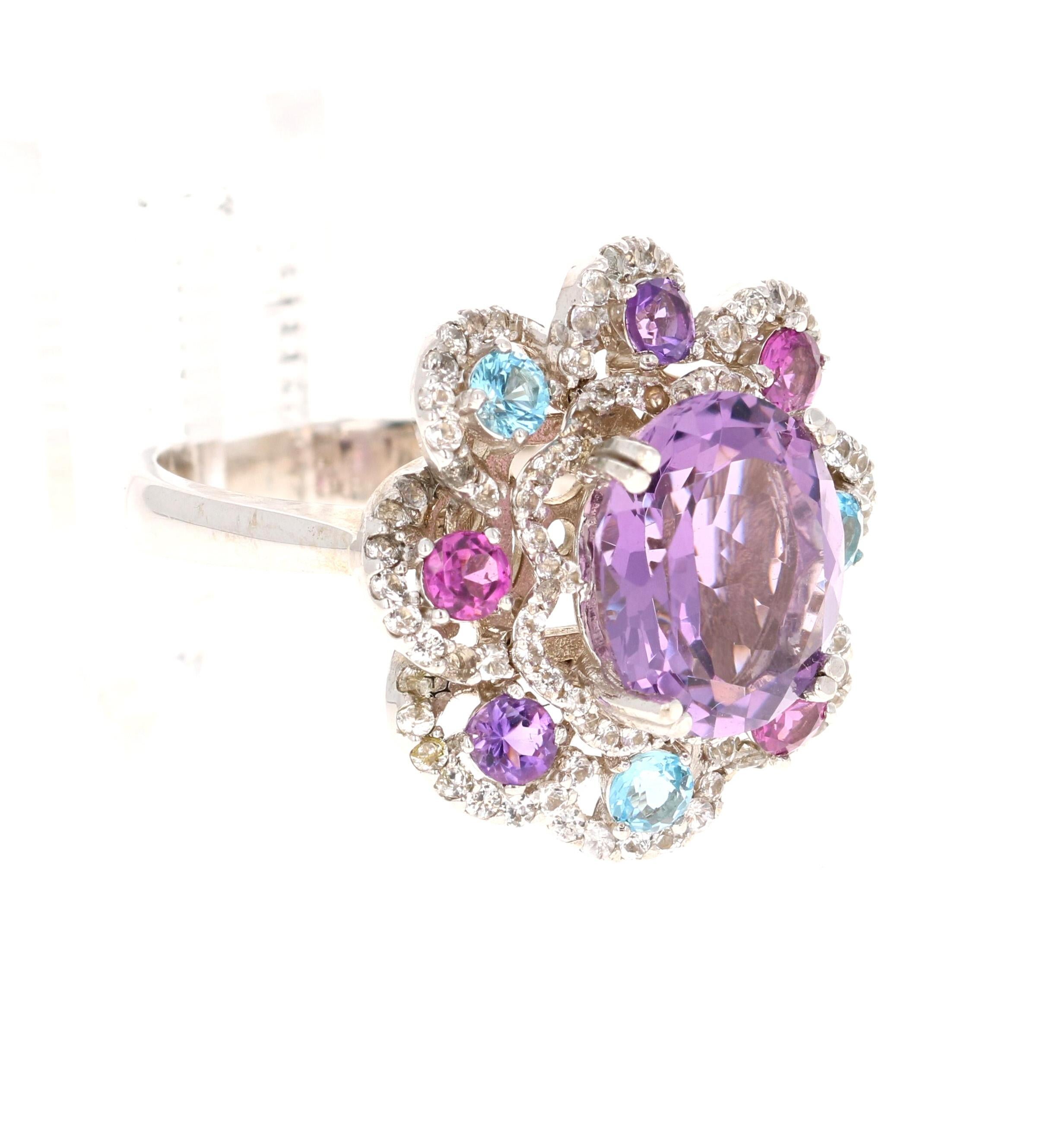 5.87 Carat Amethyst Sapphire and Topaz White Gold Cocktail Ring

This beautiful ring has a Oval Cut 3.79 carat Amethyst that measures at approximately 10 mm x 12 mm. There are Blue Topaz, Garnet, Amethysts surrounding the ring that weigh 0.98