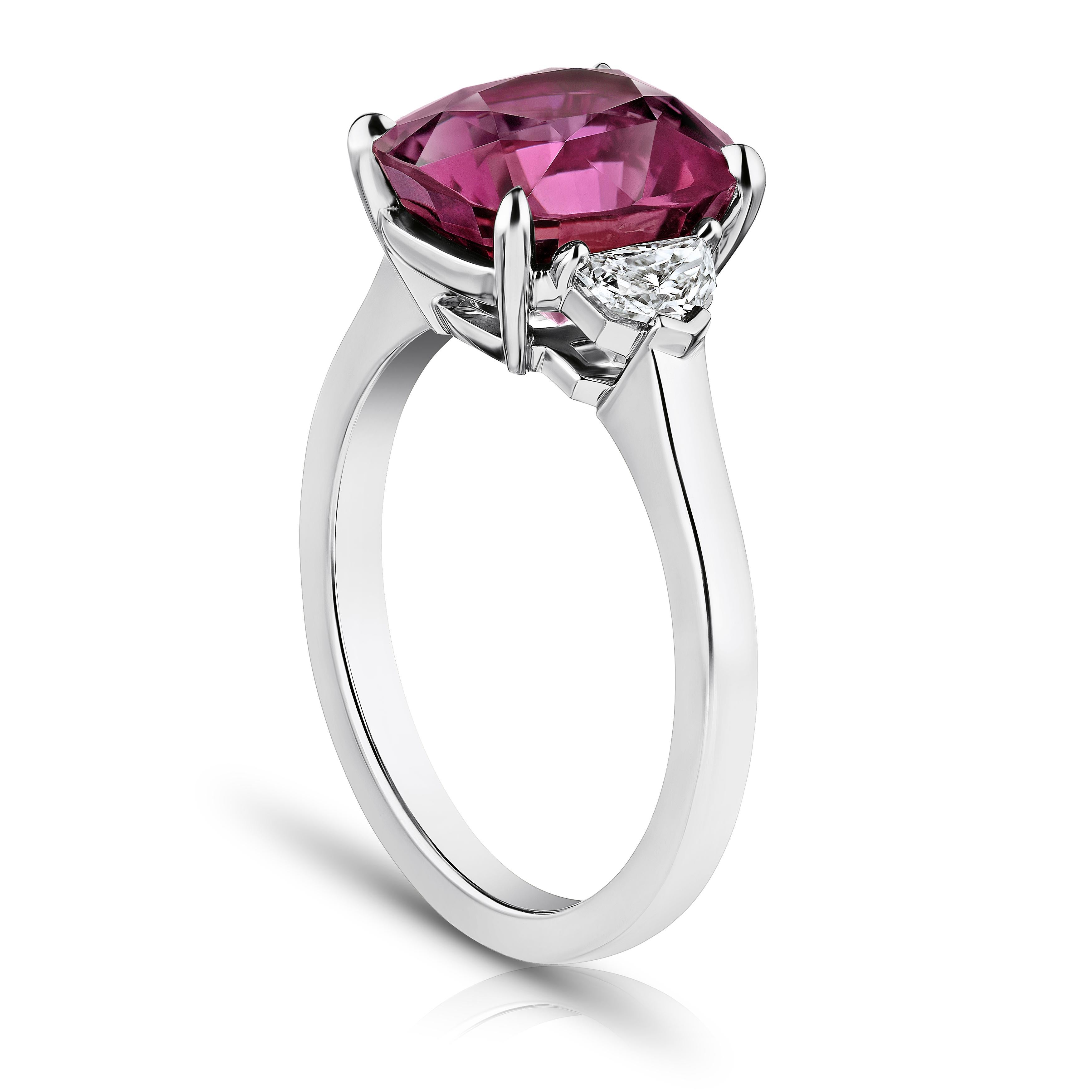 5.88 carat cushion pinkish red sapphire with epaulet cut diamonds .34 carats set in a platinum ring. Size 7.  Resizing ring to your finger size is included. 