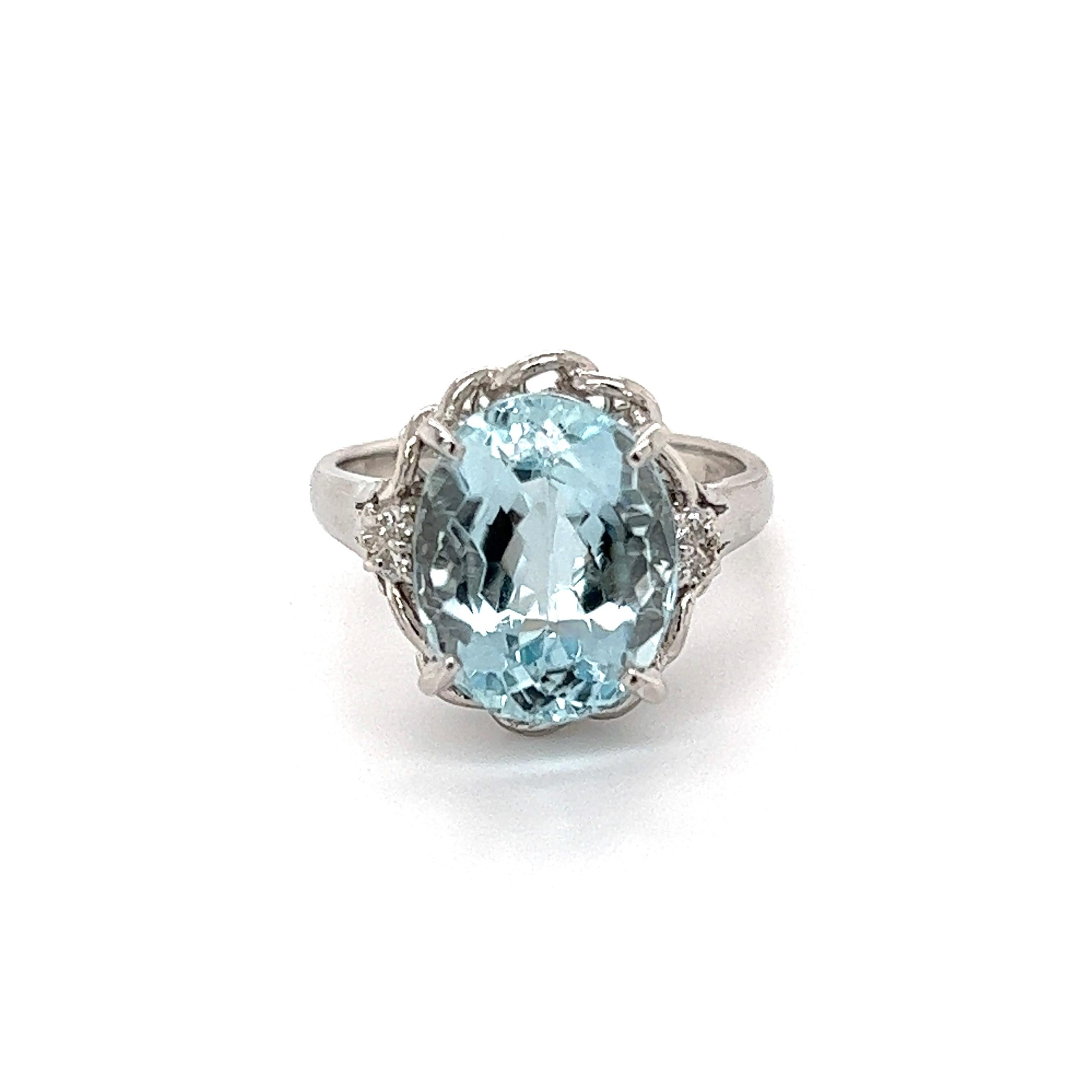 Simply Beautiful! Aquamarine and Diamond Cocktail Ring. Centering a securely nestled Hand set 5.88 Carat Oval Aquamarine with Diamonds on either side, weighing approx. 0.04tcw. Hand crafted Platinum mounting. Dimensions: 1.04: l x 0.75” w x 0.58” h