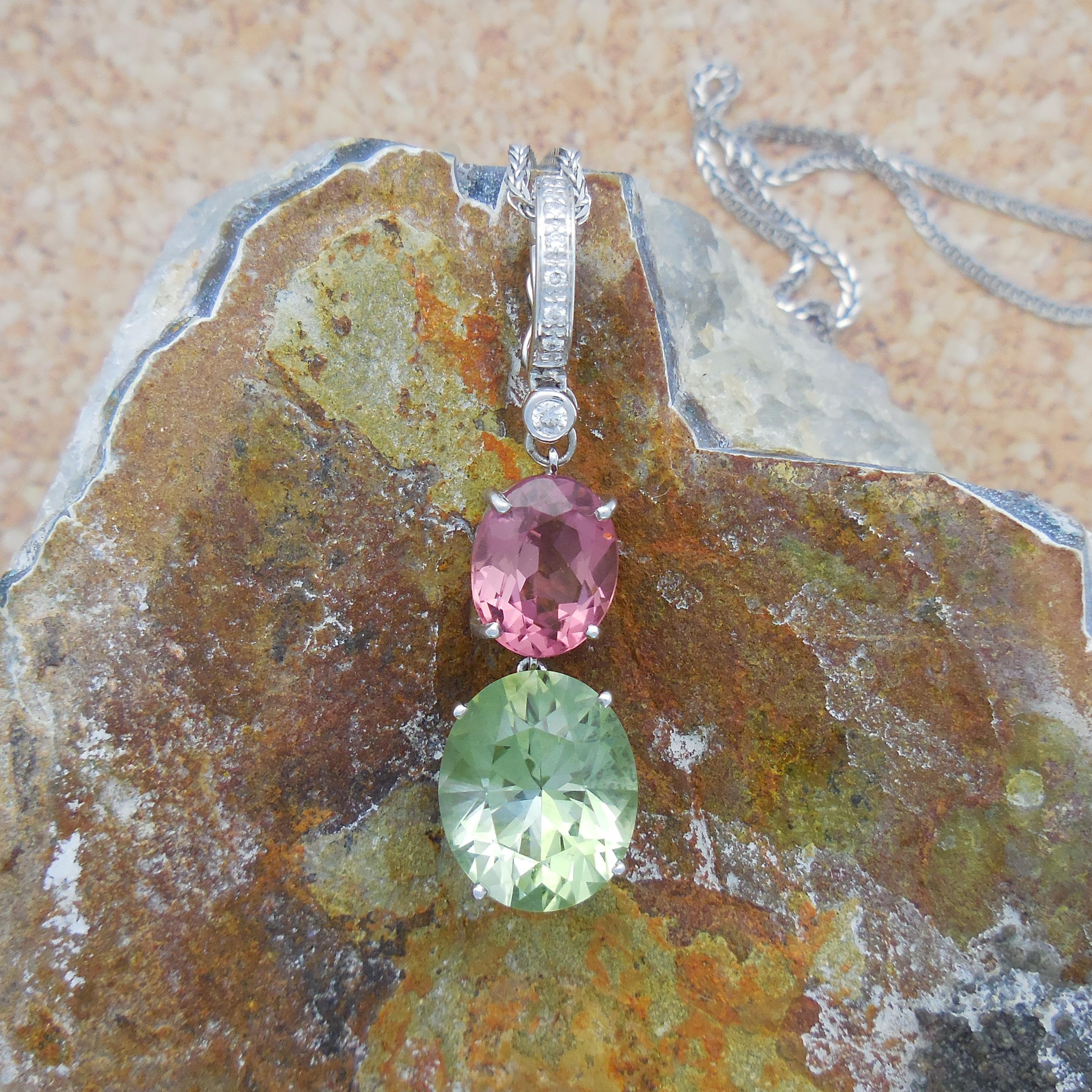 This diamond set enhancer showcases a stunning oval Mint Quartz with a weight of 5.886 carats and a stunning oval pink tourmaline (weight 3.05 Carat), surrounded by small grain set round diamonds. This is a detachable pendant with a beautiful colour