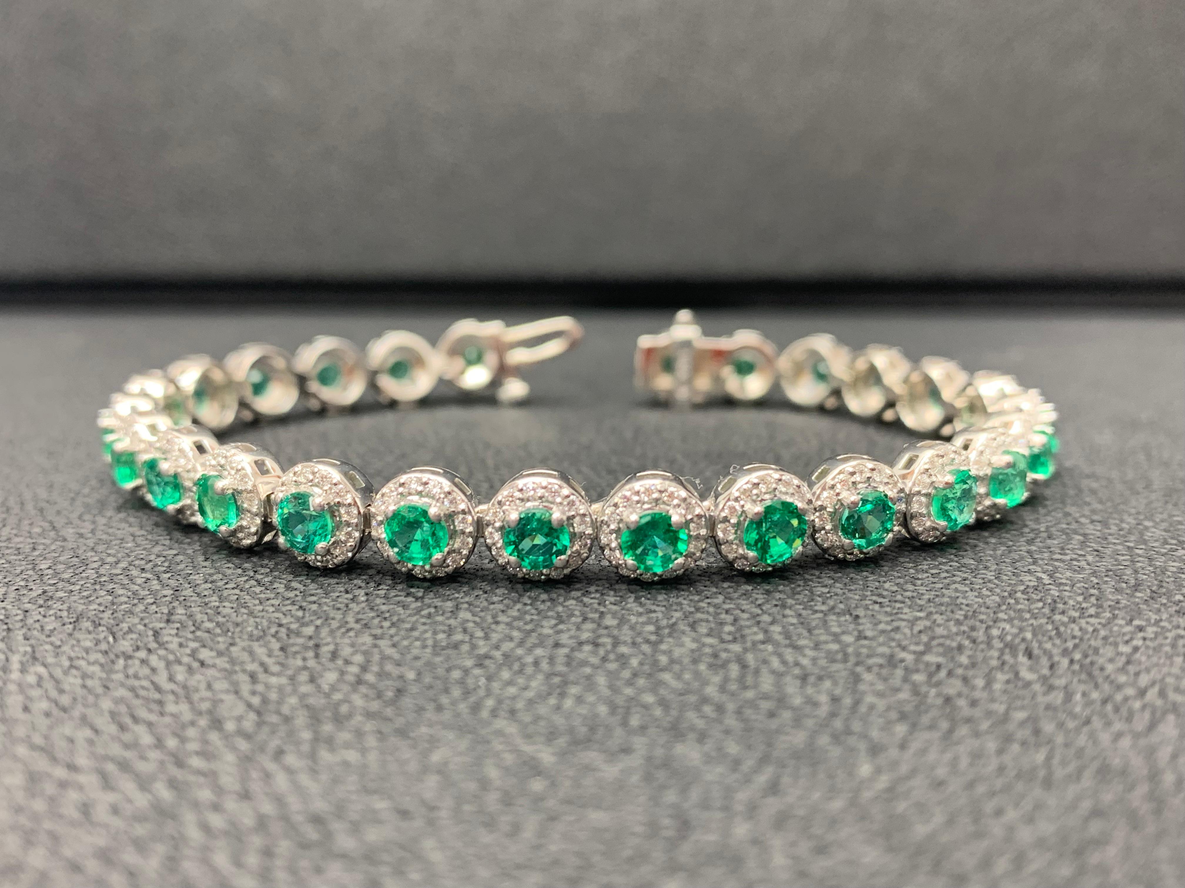 Add color to your style with this gorgeous Emerald bracelet. Features 26 Round cut Emeralds surrounded by a single row of sparkling round diamonds in a halo setting. Emeralds and diamonds weigh 5.88 carats and 1.43 carats total respectively. Made in