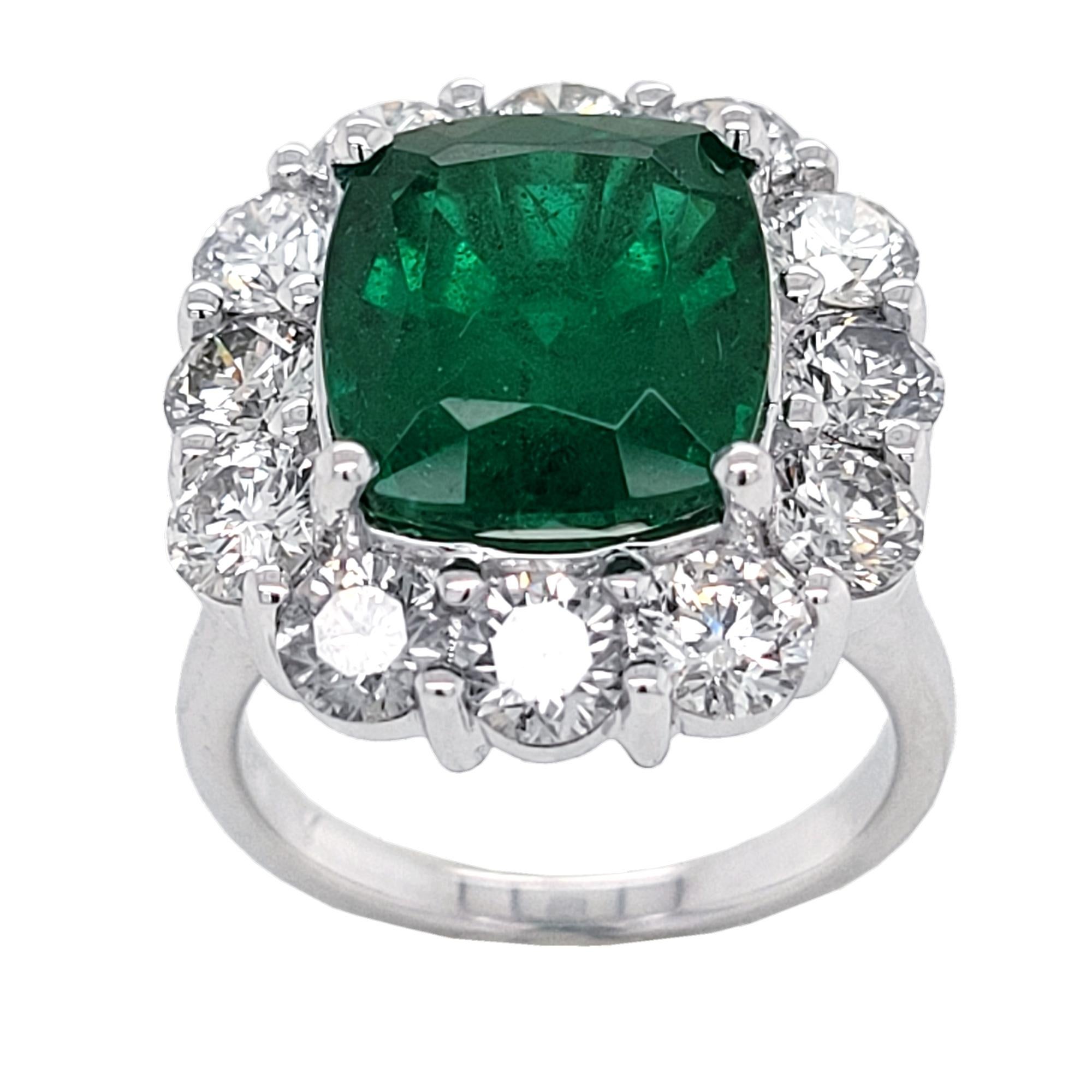 A beautiful color 5.88 Ct Cushion shaped Natural Emerald set in the center of an 18K pave set diamond engagement ring with a halo with Total 2.90 Ct Diamonds. 

Details:
Center Stone: 5.88 carat GIA Certified Cushion Emerald
Side Stone Diamonds: