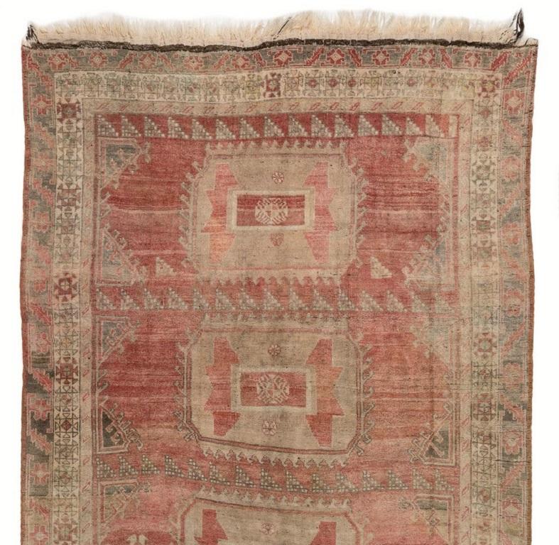 Vintage Turkish runner rug from Central Anatolia in soft, striated madder red and stone beige colors featuring a design of quirky, geometrical multiple medallions . Finely hand-knotted with even medium wool pile on wool foundation. Very good