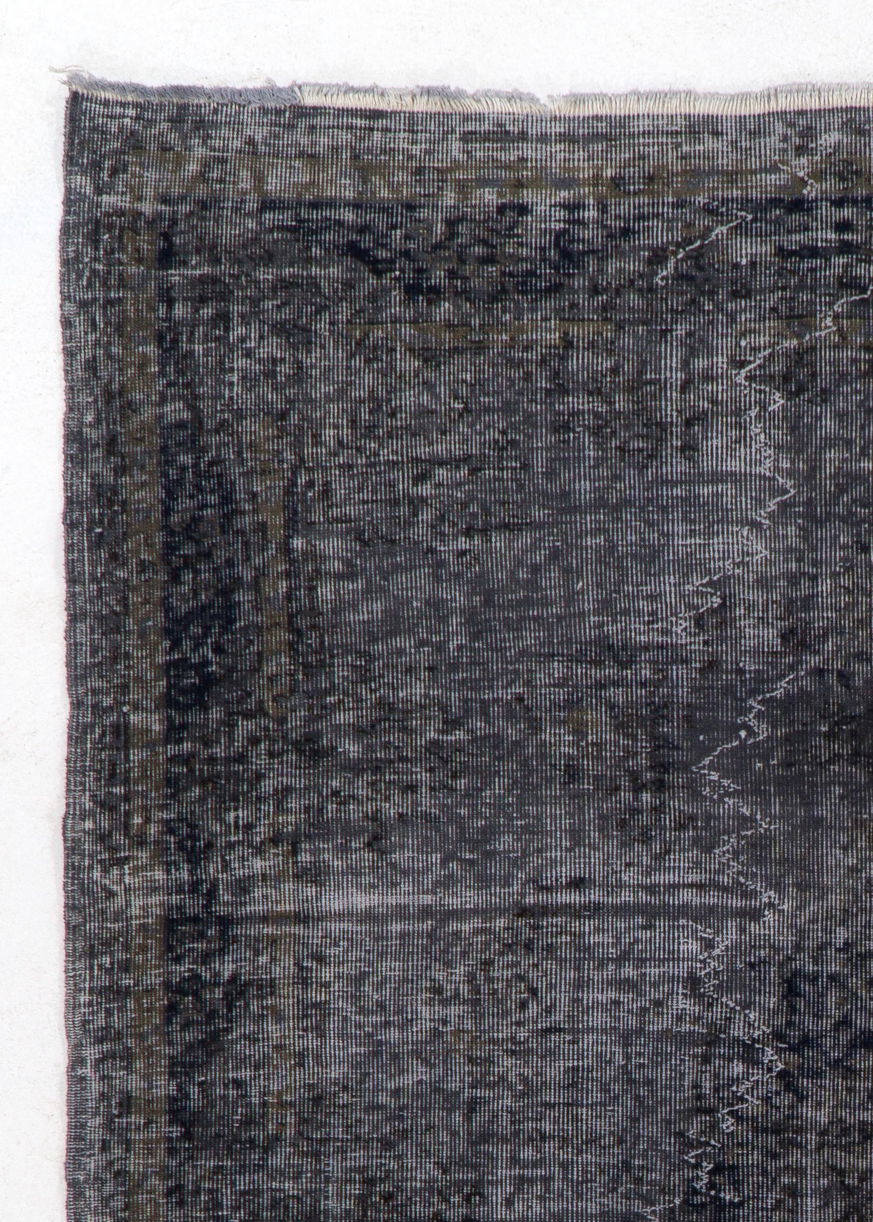A vintage Turkish area rug re-dyed in charcoal gray color for contemporary interiors.
Finely hand knotted, low wool pile on cotton foundation. Professionally washed.
Sturdy and can be used on a high traffic area, suitable for both residential and
