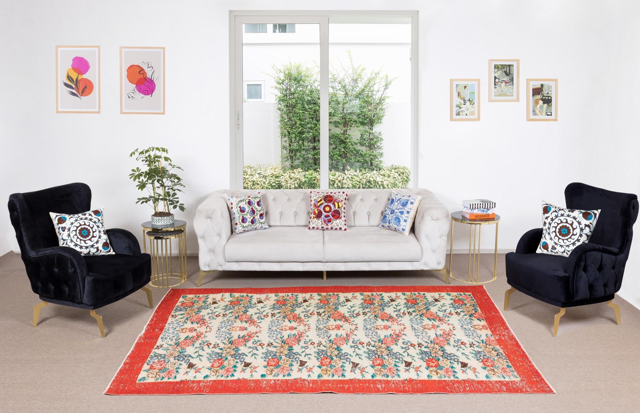 A vintage Turkish area rug. It was hand-knotted in the 1960s and all-over floral design and a solid red main border. Low wool pile on finely woven cotton foundation. Sturdy and can be used on a high traffic area, suitable for both residential and