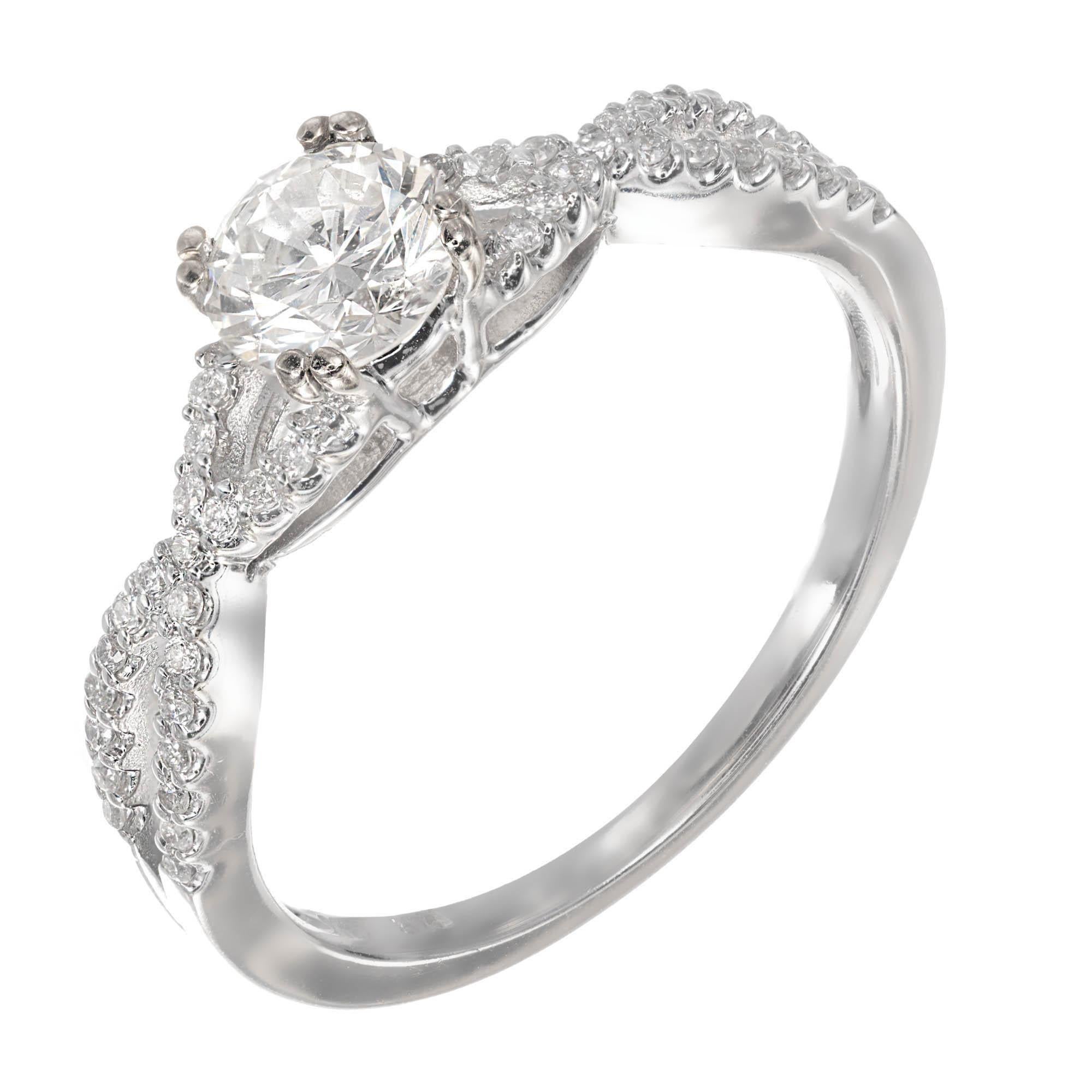 Intertwined 14k white gold diamond engagement ring with a bright sparkly white center diamond. The 2 rows of full cut diamonds join to hold the center diamond.

1 round brilliant cut diamond, approx. total weight .59ct, I, SI1, EGL certificate