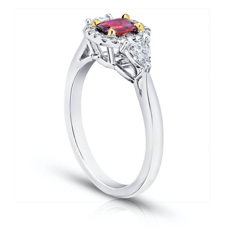 .59 Carat Emerald Cut (natural no heat) Red Ruby with 2 arrow cut diamonds .38 and 18 brilliant cut diamonds weighing .11 carats set in a platinum with 18k yellow gold ring.
