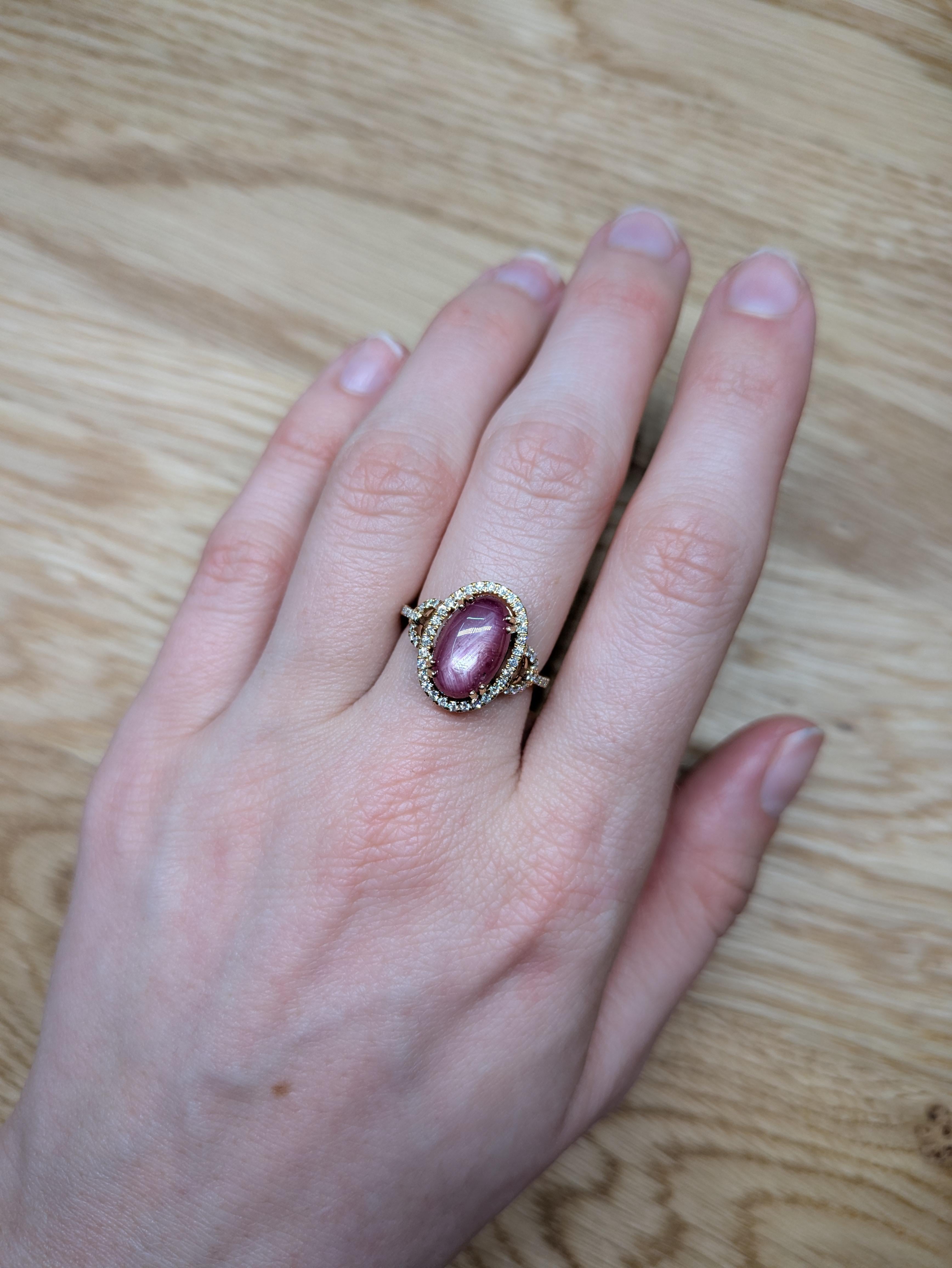 This stunning 5.87-carat star ruby ring features a captivating star-shaped shimmer at its center, surrounded by a brilliant halo of earth-mined diamonds. Set in solid 14k real gold, this statement ring exudes elegance and luxury, making it a perfect