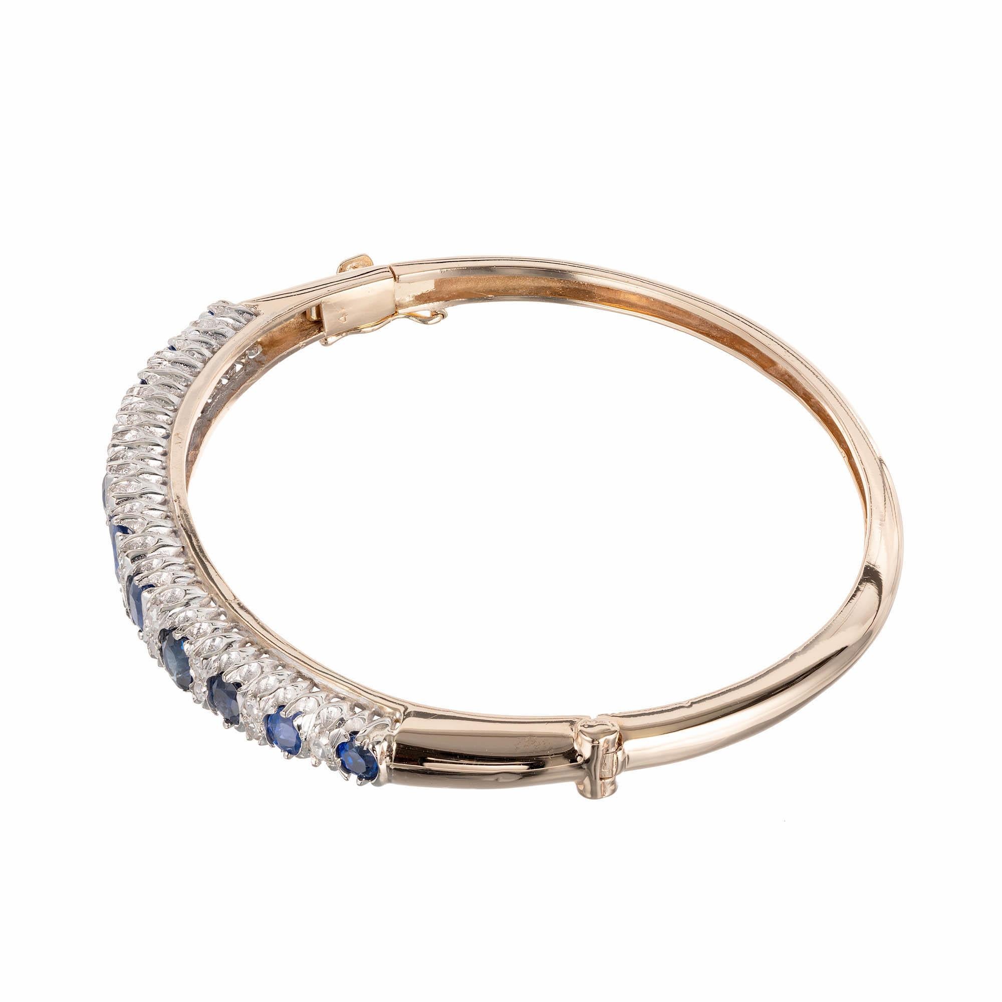 1930's handmade sapphire and diamond 14k yellow gold bangle bracelet.  White gold top set with bright white diamonds and natural blue no heat and no enhancements round graduated Sapphires.

1 Totally natural no heat and no enhancement Sapphire