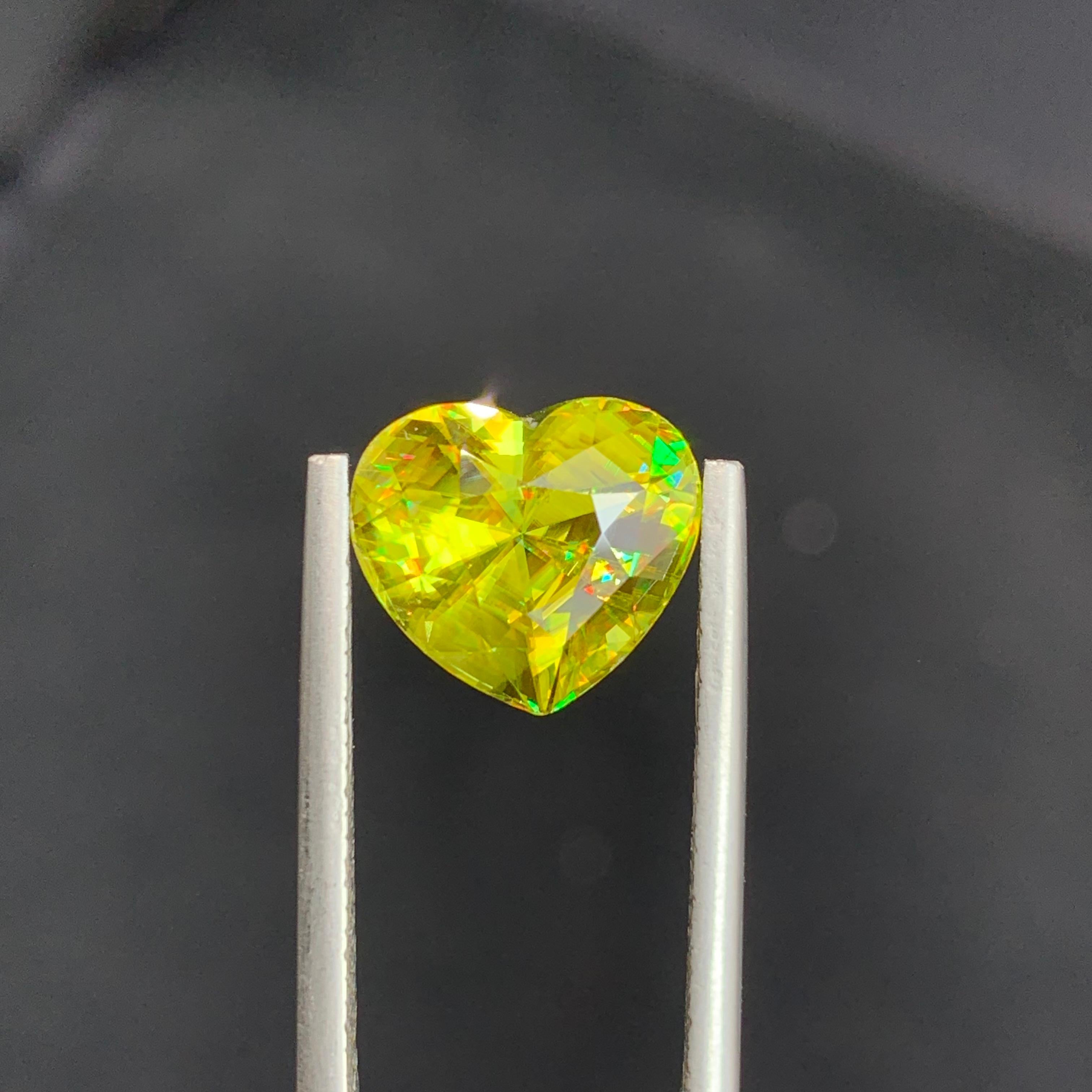 Loose Sphene
Weight: 5.90 Carats
Dimension: 10.2 x 11.4 x 7.5 Mm
Origin: Warsak Pakistan
Shape: Heart 
Color: Yellow Fire
Treatment: Non
Certificate: On Demand

Sphene, also known as titanite, is a remarkable and lesser-known gemstone that has