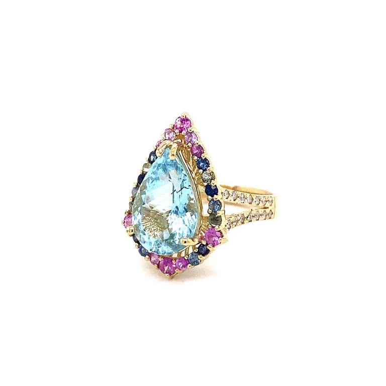 5.91 Carat Aquamarine Sapphire Diamond 14K Yellow Gold Cocktail Ring

This ring has a gorgeous 4.66 Carat Pear Cut Aquamarine and is surrounded by 22 Blue and Pink Sapphires that weigh 0.99 Carats.  It is further embellished with 28 Round Cut
