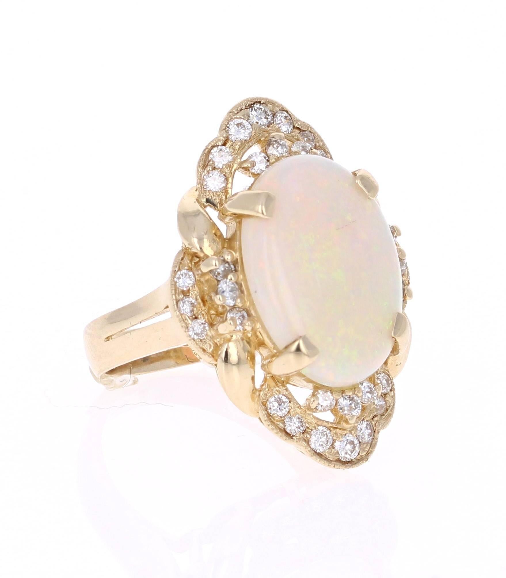 This gorgeous cocktail ring has a beautiful & large Oval Cut Australian Opal that weighs 5.25 carats and 32 Round Cut Diamonds that weigh 0.66 carats. The clarity and color of the diamonds are VS2-H.  The total carat weight of the ring is 5.91