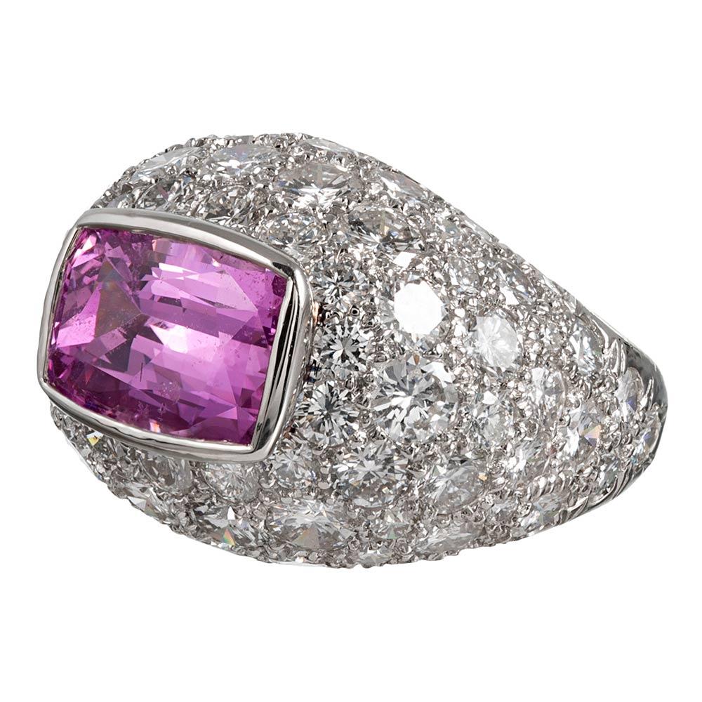 Spectacular and glamourous, this dazzling platinum ring is appointed with 8 carats of brilliant white diamonds. Sitting atop the dome is an intense pink sapphire weighing 5.91 carats. The ring offers a fun, yet important look that can be worn for