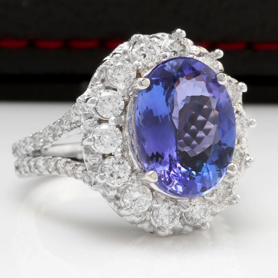 5.91 Carats Natural Very Nice Looking Tanzanite and Diamond 14K Solid White Gold Ring

Total Natural Oval Cut Tanzanite Weight is: 4.36 Carats

Tanzanite Treatment: Heat

Tanzanite Measures: 12.30 x 9.30mm

Natural Round Diamonds Weight: 1.55 Carats