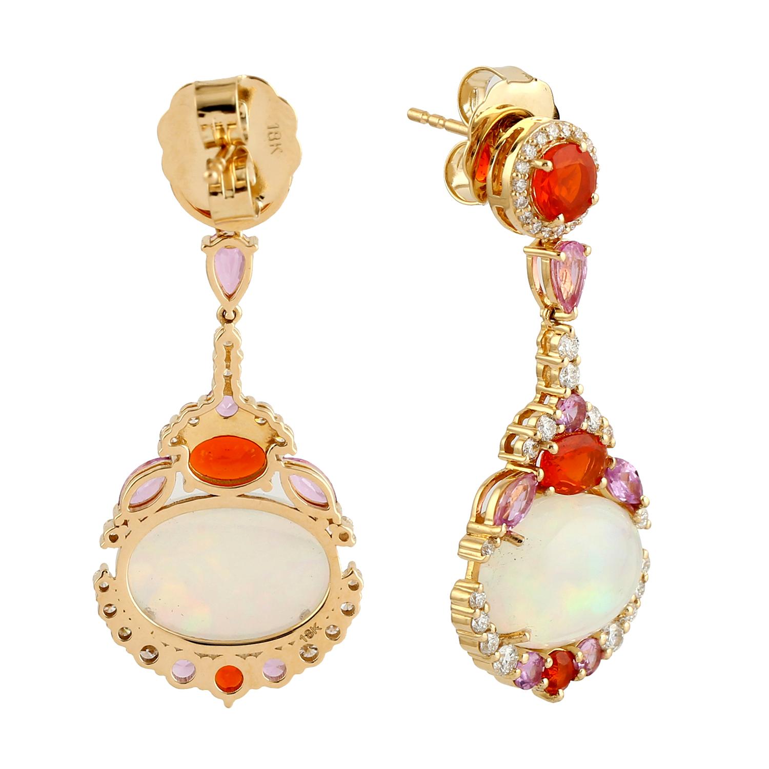 Cast in 18 karat gold. These stud earrings are hand set in 5.91 carats Ethiopian opal, 1.62 carats pink sapphire, 1.45 carats fire opal and .86 carats of sparkling diamonds. 

FOLLOW MEGHNA JEWELS storefront to view the latest collection & exclusive