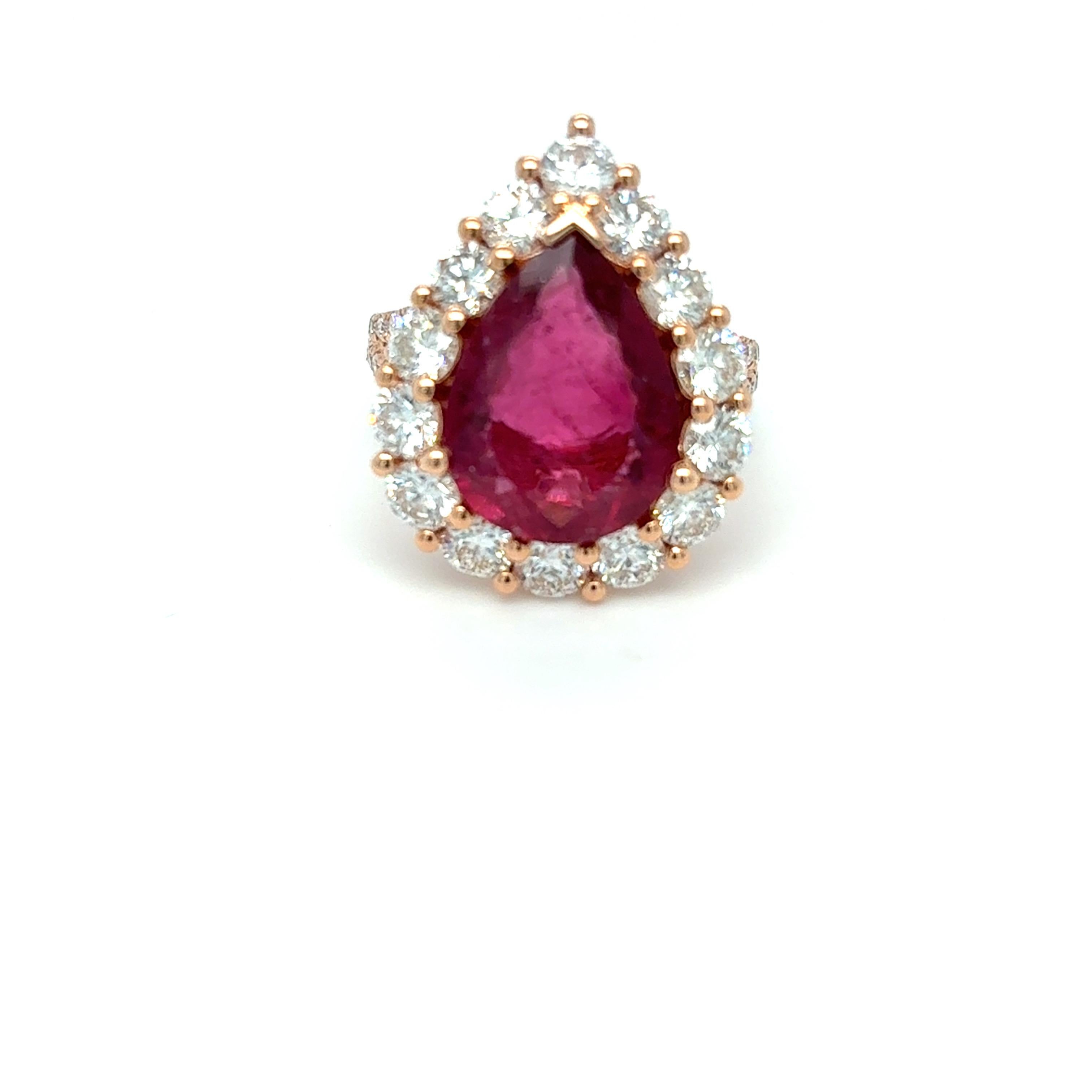 Exquisite 5.92-carat rubellite and diamond ring featuring a stunning pear-cut rubellite at its center, encircled by a sparkling halo of diamonds. The diamond-accented shank and intricately designed under-gallery enhance its elegance, with a total