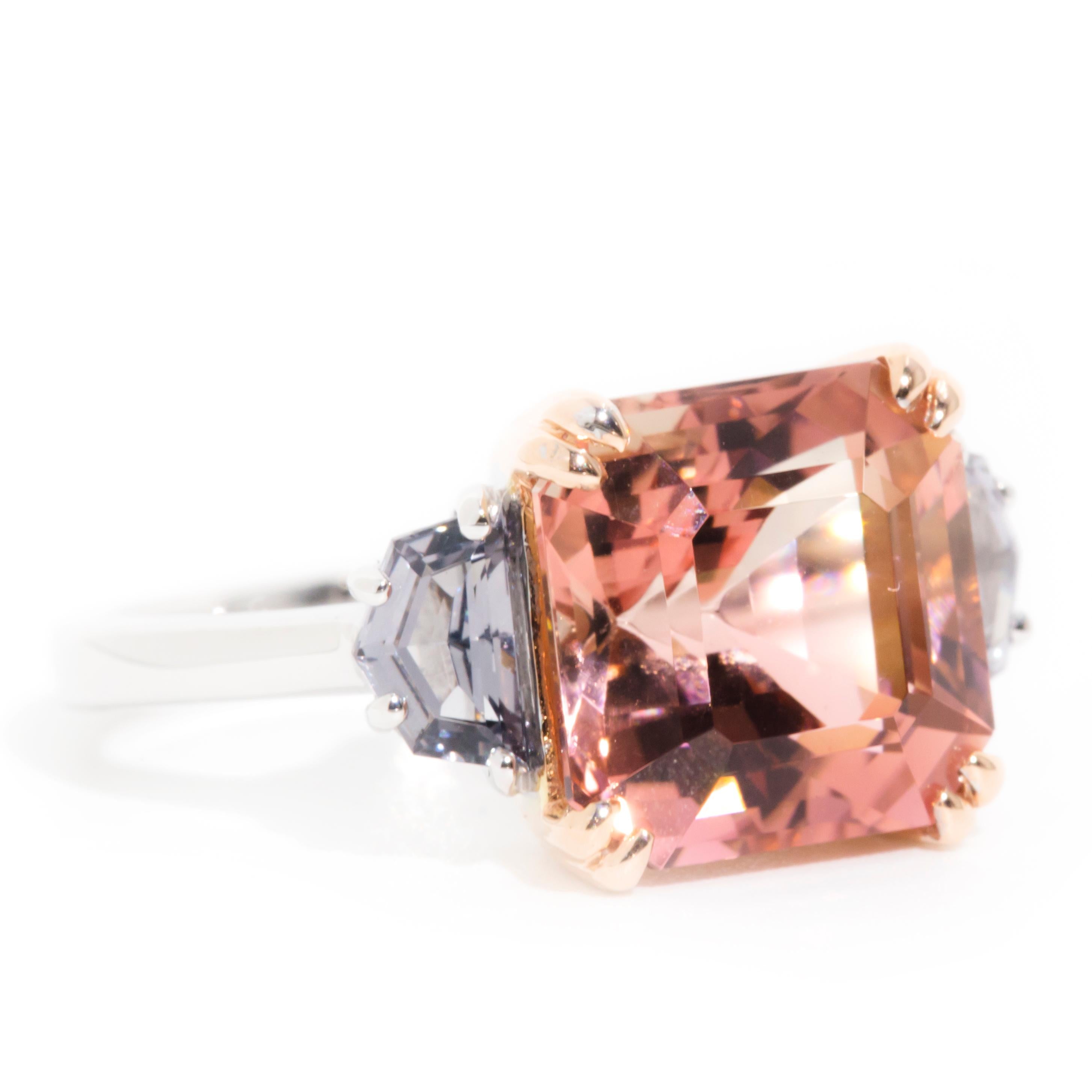 Lovingly crafted in 18 carat white gold, this delightful three-stone ring features a gleaming 5.93 carat bi-colour tourmaline flanked by a pair of enchanting purple spinels. This captivating ring has been named The Jimena Ring. She is as unique as