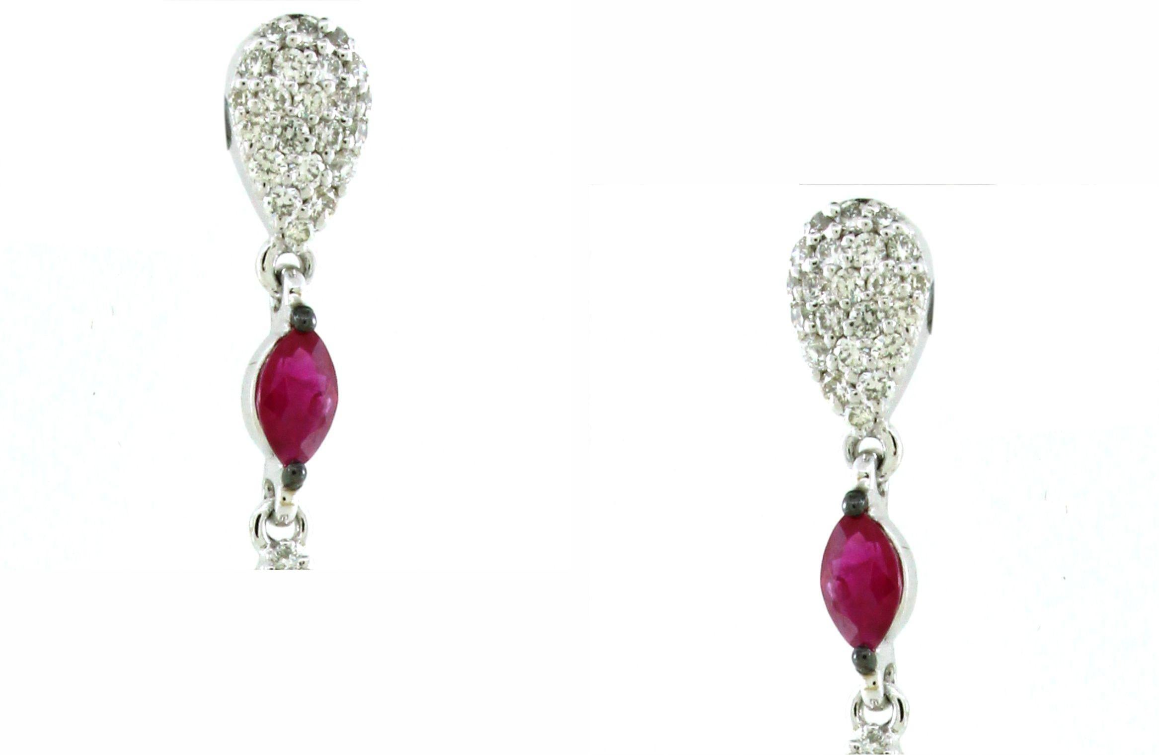 Introducing our exquisite Ruby Drop Statement Earrings, meticulously crafted in opulent 18K white gold, weighing a total of 9.66 grams. These captivating earrings boast a magnificent display of rubies, featuring two round rubies totaling 4.8 carats