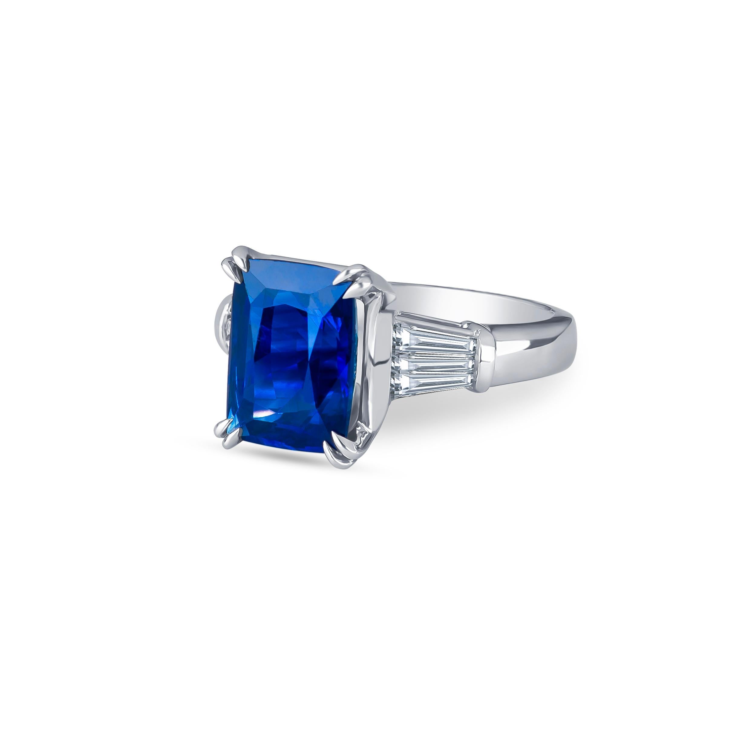 5.96 Carat Natural Ceylon blue sapphire (AGL certified) cushion cut with 0.80 carat total weight in baguette diamonds, set in a platinum ring. Ring size 6, may be sized larger or smaller upon request.