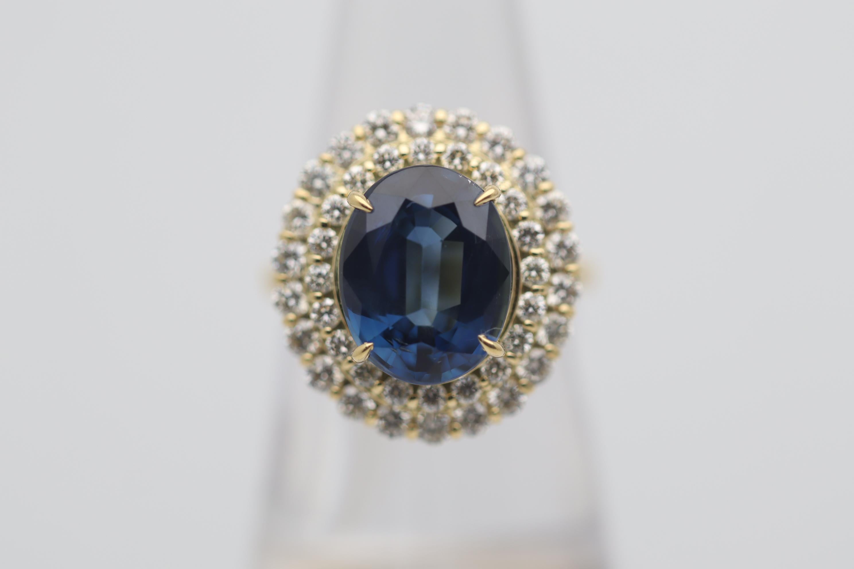 A sleek and sexy ring featuring a fine blue sapphire weighing an impressive 5.96 carats. It has a soft intense blue color which has excellent brightness and light returns as well as being eye clean with no visible inclusions. It is complemented by