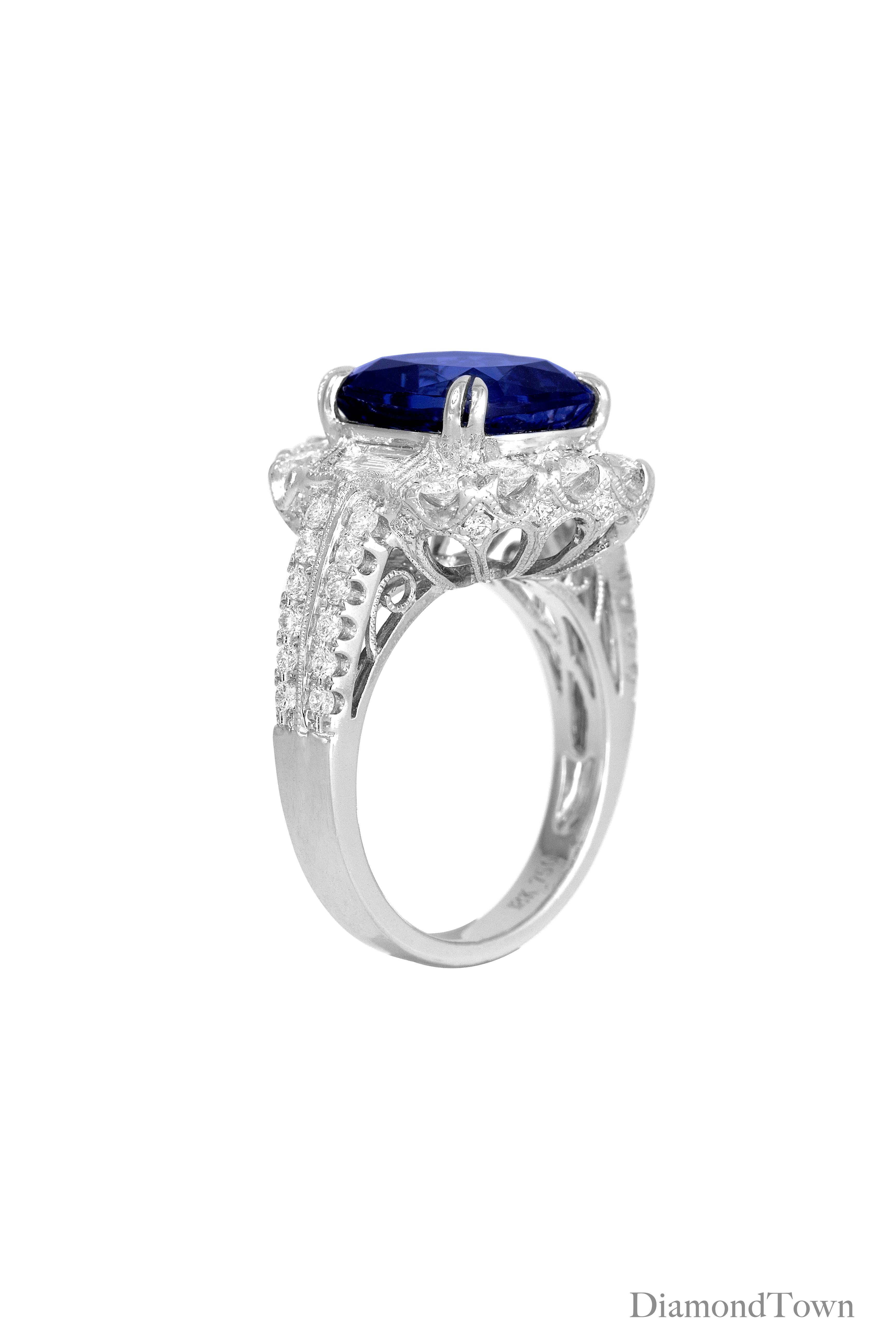 (DiamondTown) This ring sparkles with a 5.96 Carat Tanzanite center, flanked by 2 tapered baguette diamonds and a halo of round diamonds, and additional diamonds trailing down the side shank, bringing the total diamond weight to 1.47