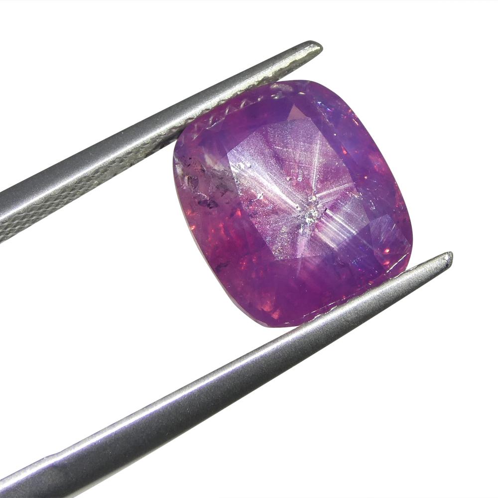 This unique 5.96ct Cushion Trapiche-Like Pinkish Purple Sapphire, GIA certified from Pakistan, captivates with its intricate patterns and mesmerizing hue. Its exquisite colour, a delightful blend of pink and purple, paints a poetic picture of