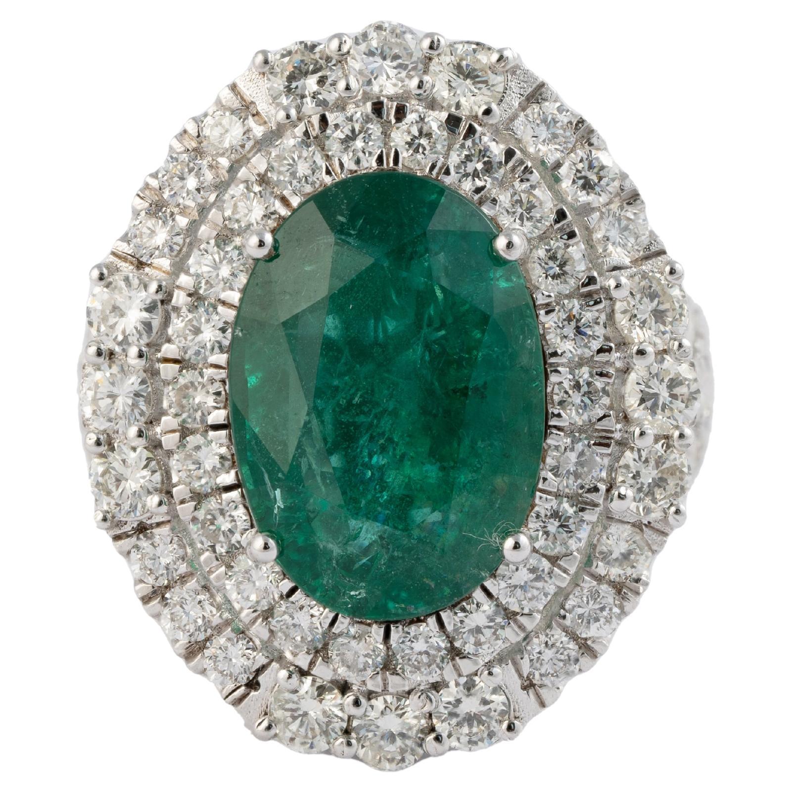 this is a stunning natural Zambian Emerald  ring with very high quality Emerald and very good quality diamonds ( vsi ) and G colour

emeralds : 5.97cts
diamonds: 2.74cts
gold :7.048gms
