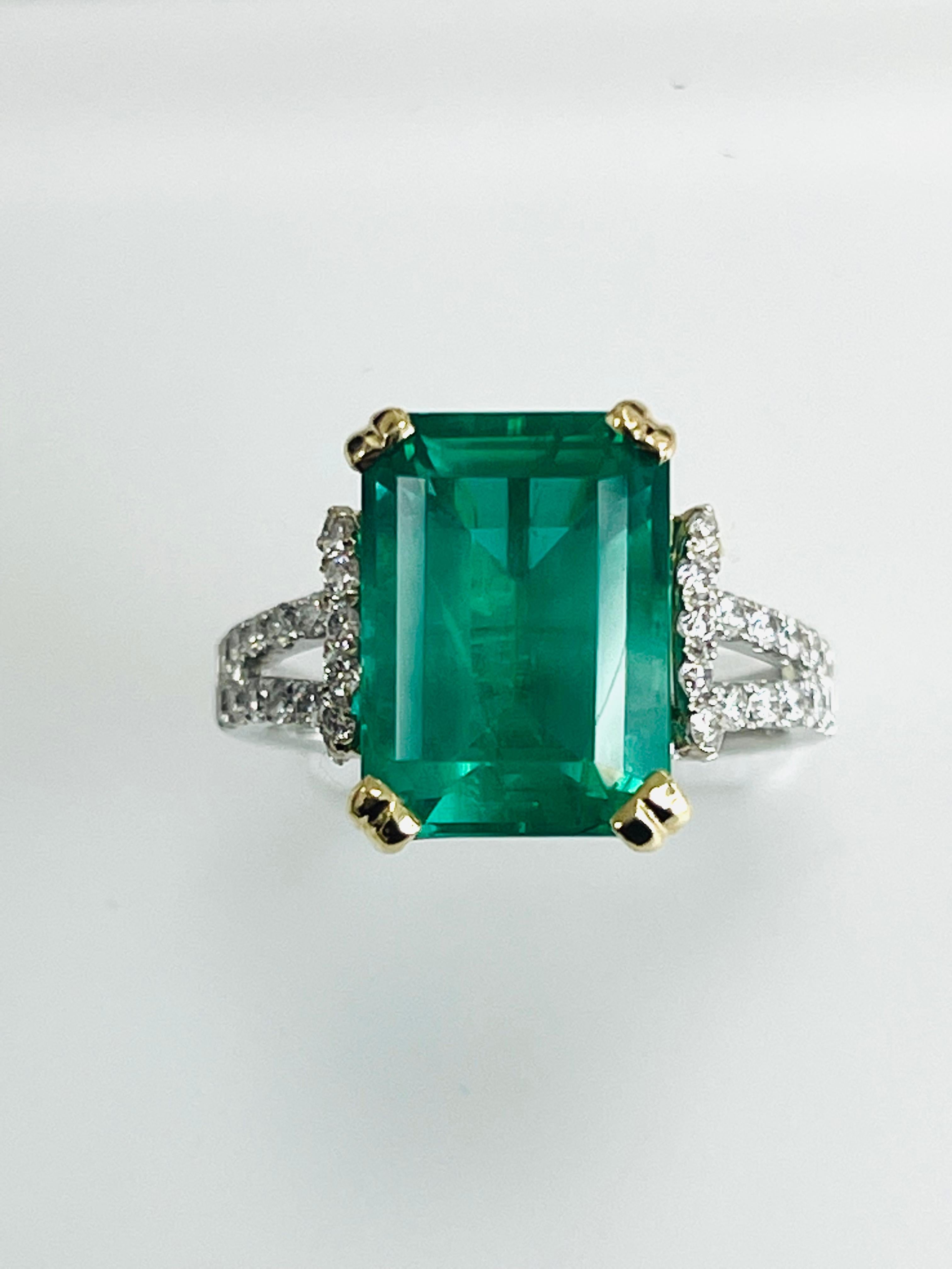 5.97 Carat Brazilian Emerald cut emerlad set in 18k whit gold ring , yellow basket ,split prongs , with 0.68 carat diamonds,