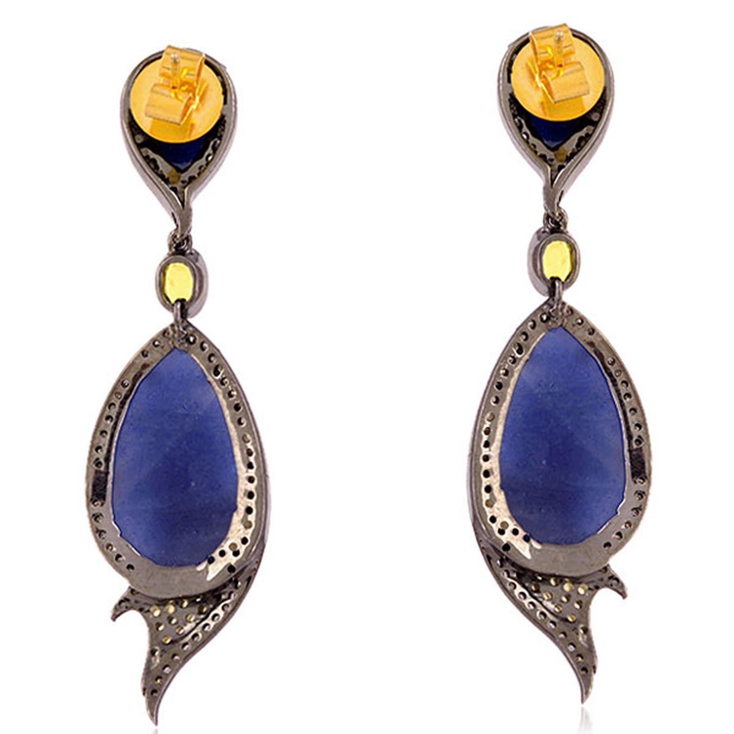 Cast in 18-karat gold and sterling silver. These beautiful earrings are hand set in 24.27 carats blue sapphire and 1.29 carats of sparkling diamonds. 

FOLLOW  MEGHNA JEWELS storefront to view the latest collection & exclusive pieces.  Meghna Jewels
