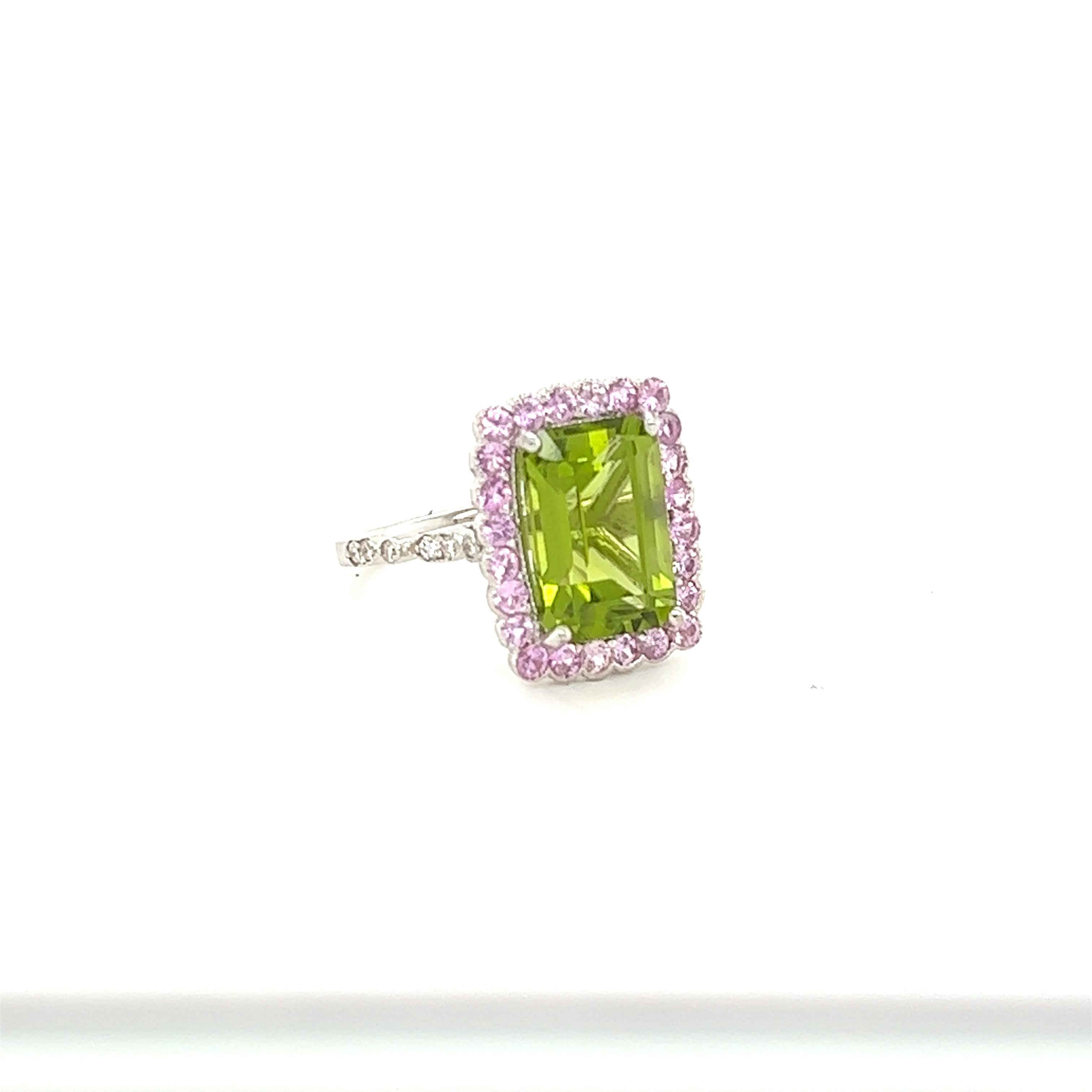 This ring has a 4.98 Carat Emerald Cut Peridot and 24 Pink Sapphires that weigh 0.86 Carats and 12 Round Cut Diamonds that weigh 0.14 carats (Clarity: VS, Color: H) The total carat weight of the ring is 5.98 Carats. The Peridot measures at 12 mm x 8