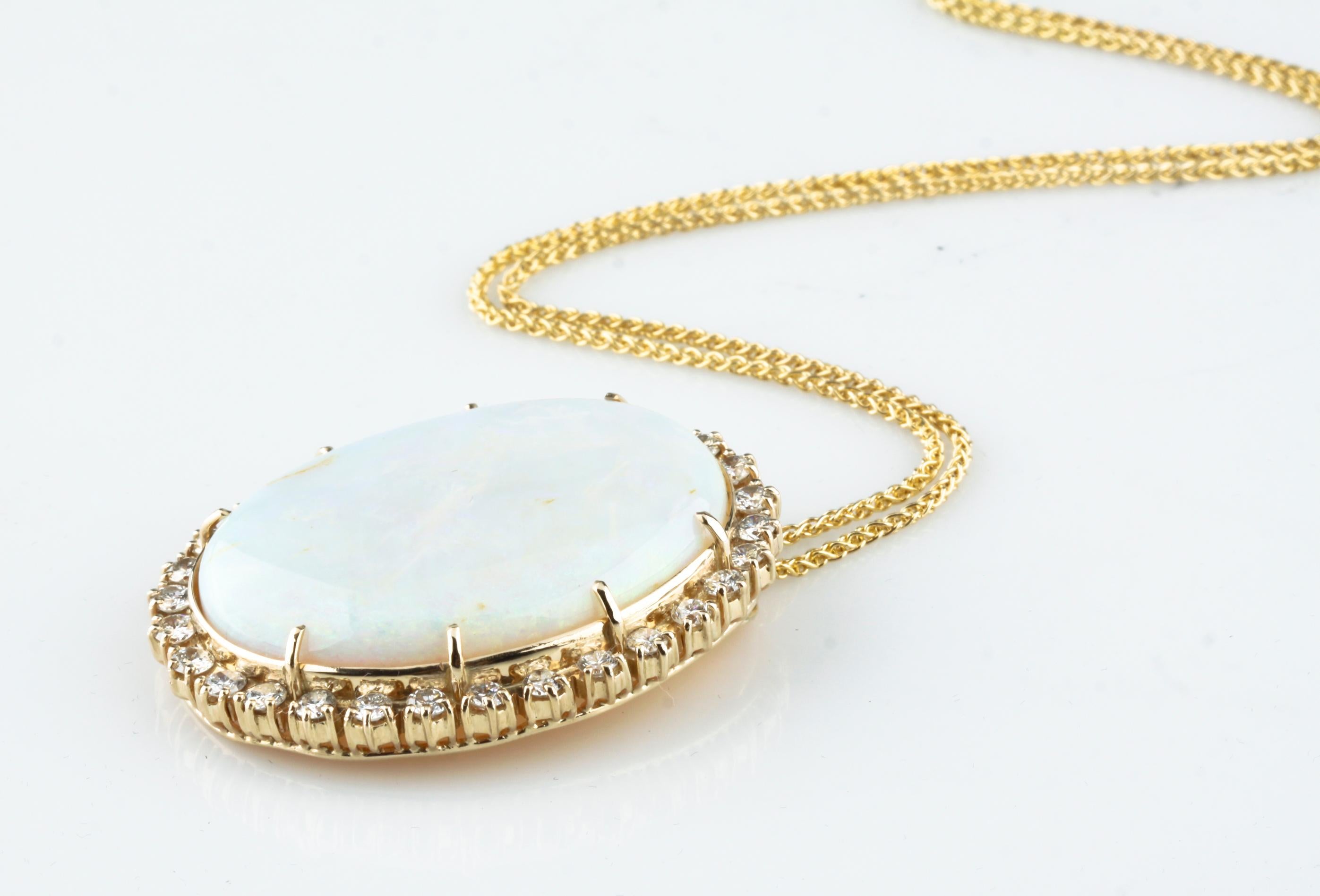 One Electronically Tested 14KT Yellow Gold Ladies Cast Fashion Pendant
Bright Polish Finish
Good Condition
Pendant is Centered with a Prong-Set Oval Opal
Prong Set Around the Opal are Thirty (30) Round Brilliant Cut Diamonds
Pendant Measures 45.21