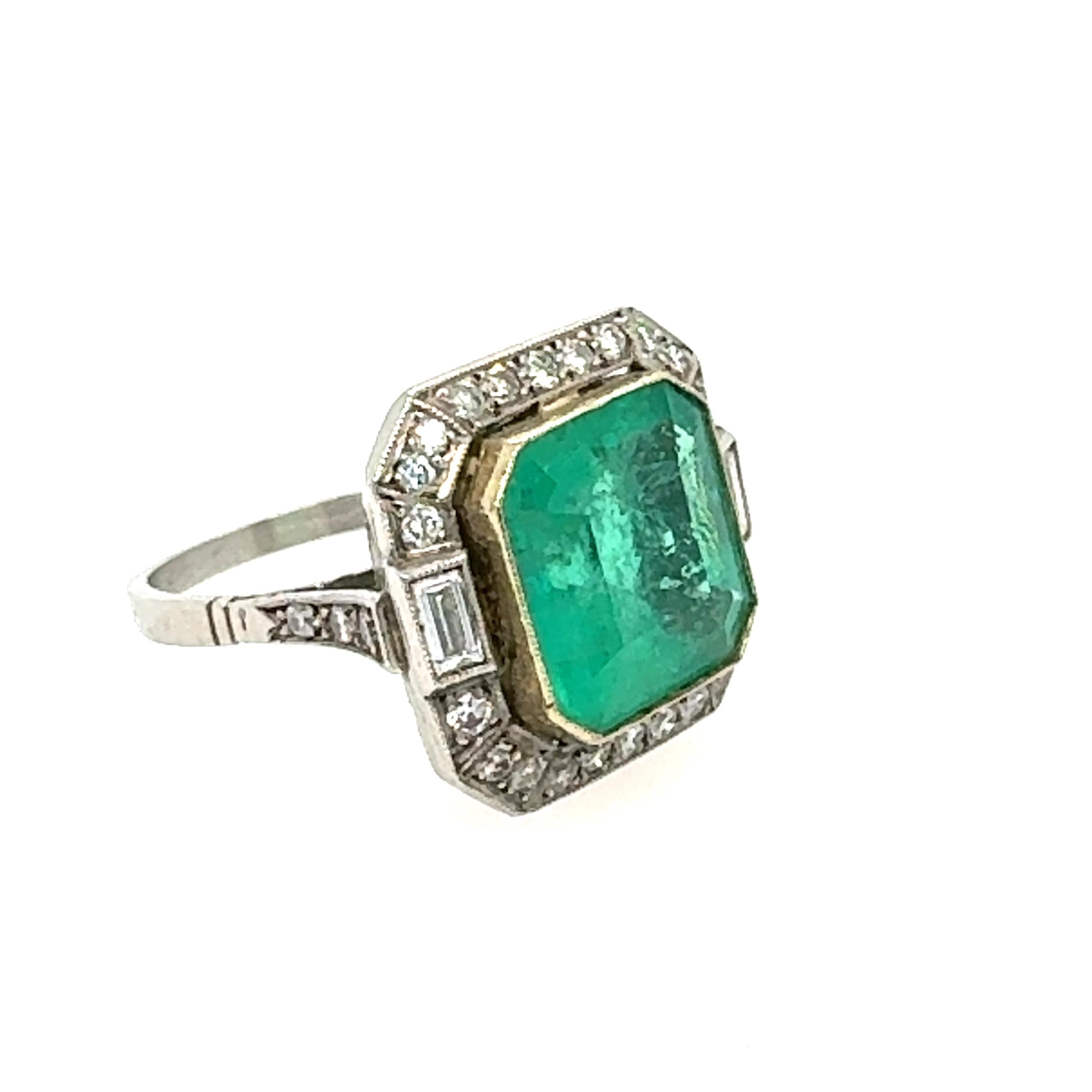 Discover this exquisite emerald ring  featuring a 5.98‑carat Colombian emerald, masterfully emerald‑cut and bezel‑set in warm 18k yellow gold. The vivid, saturated green center stone is framed by 28 round brilliant diamonds totaling approximately