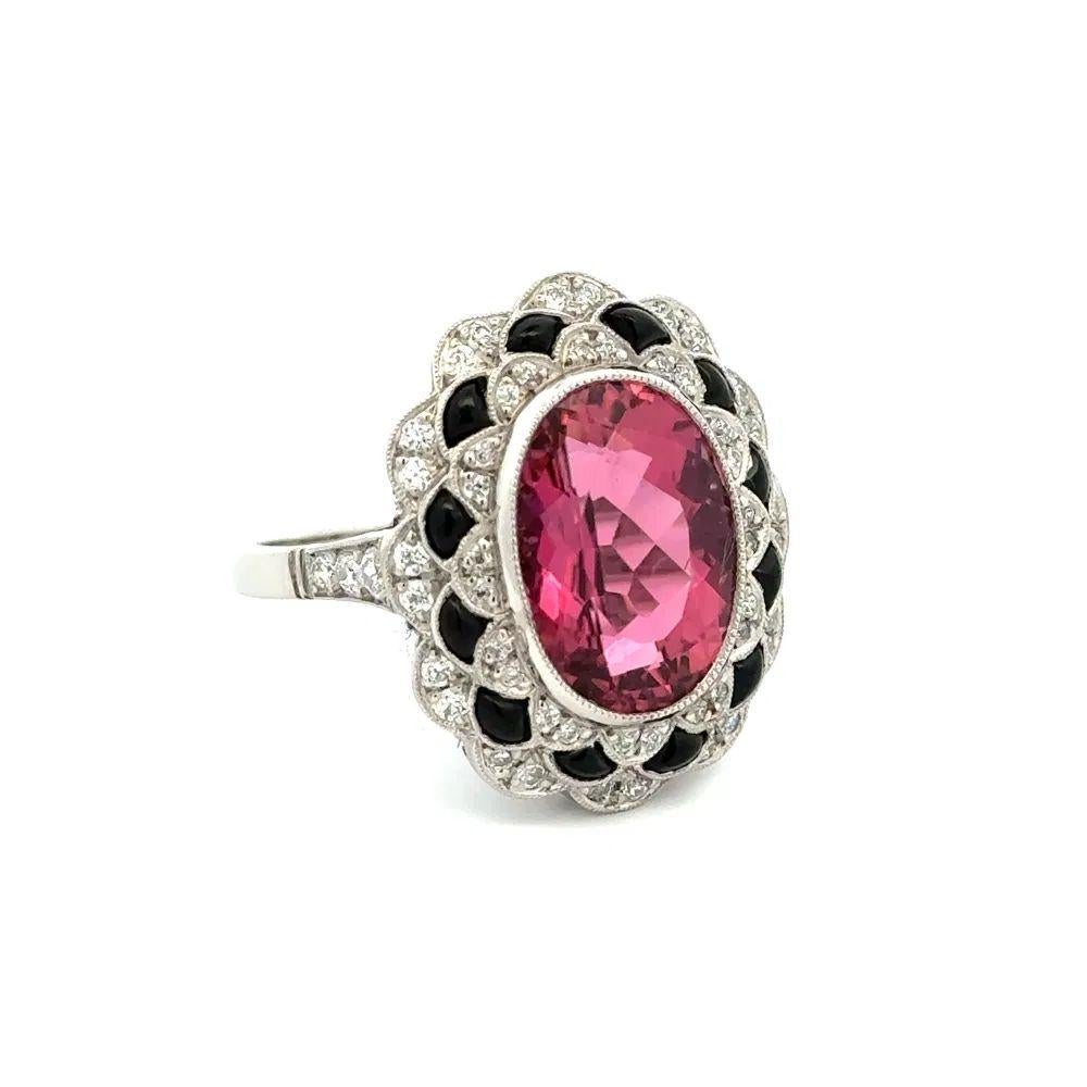 Simply Beautiful! Rubelite Tourmaline Buff Top Onyx and OEC Diamond Platinum Cocktail Ring. Showcasing a securely nestled Hand set 5.99 Carat Oval Rubelite Tourmaline. Complimented by Buff-Top Onyx and Old European Cut Diamonds. The ring is