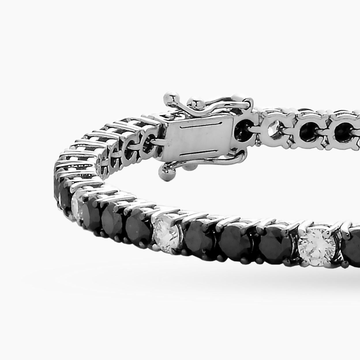 Beautiful unisex 18-karat white gold tennis bracelet with a total carat of 5.99 carat mixed set with brilliant cut black diamonds and brilliant cut natural white diamonds: color F/G, clarity V-S quality. 

This is a no turn riviera bracelet and has