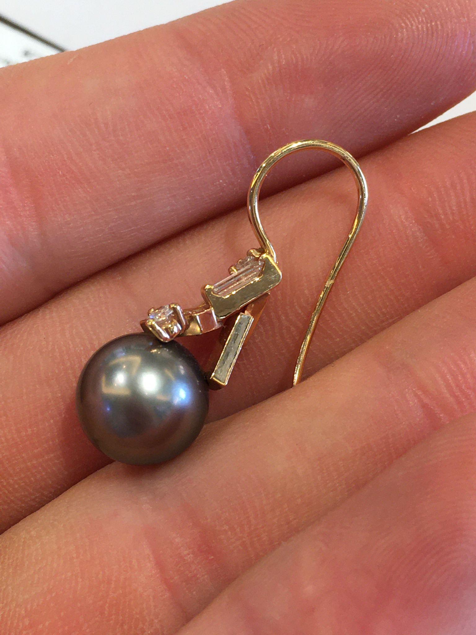 A beautiful pair of a 5+A Thaitian dark pearl 18kt yellow gold with diamond earring by mikimoto.