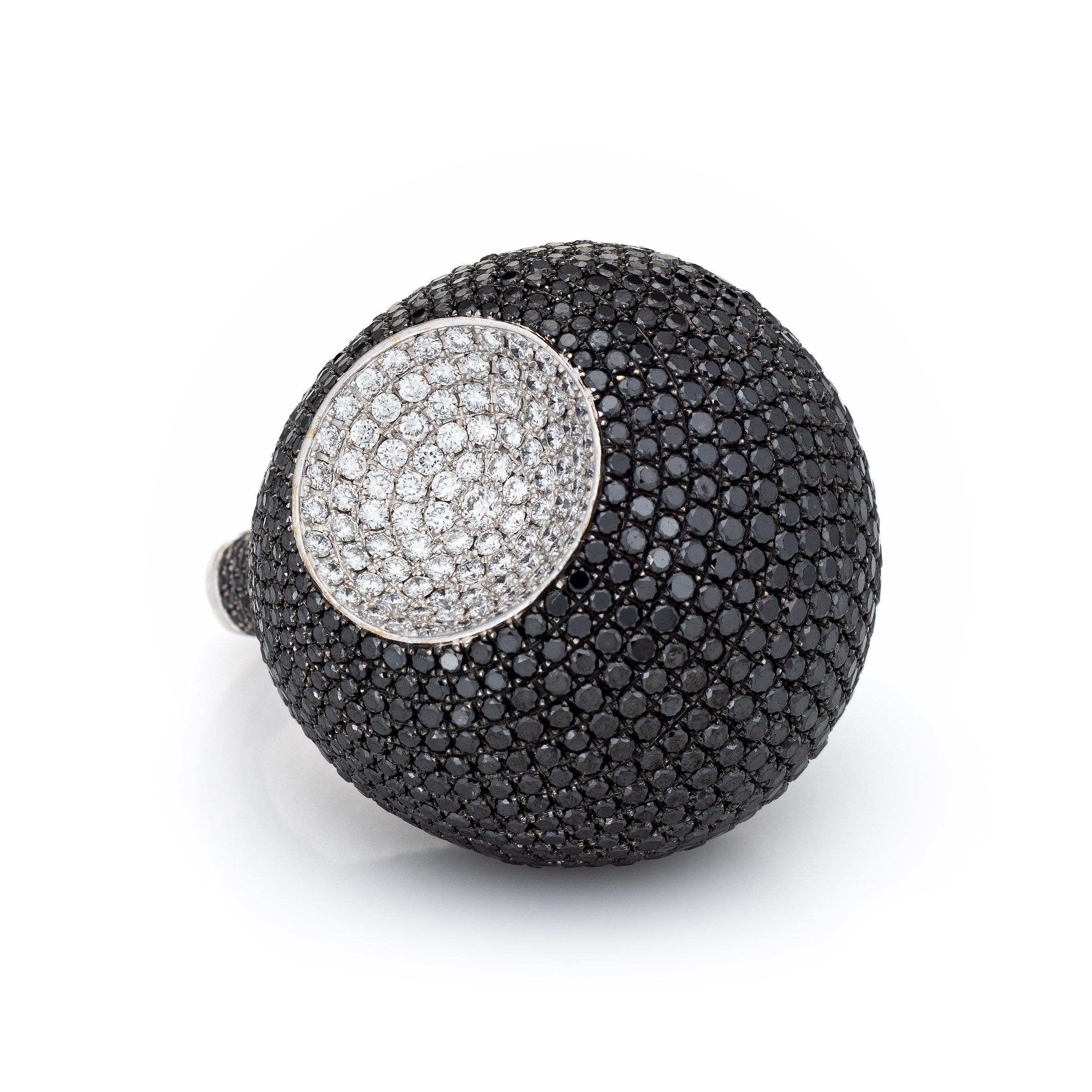 Distinct and bold black diamond 'moon crater' ring (circa 2000s) crafted in 18 karat white gold. 

Black diamond total an estimated 5 carats. White diamonds total an estimated 1 carat (estimated at G-H color and VS2-SI1 clarity). 

The large
