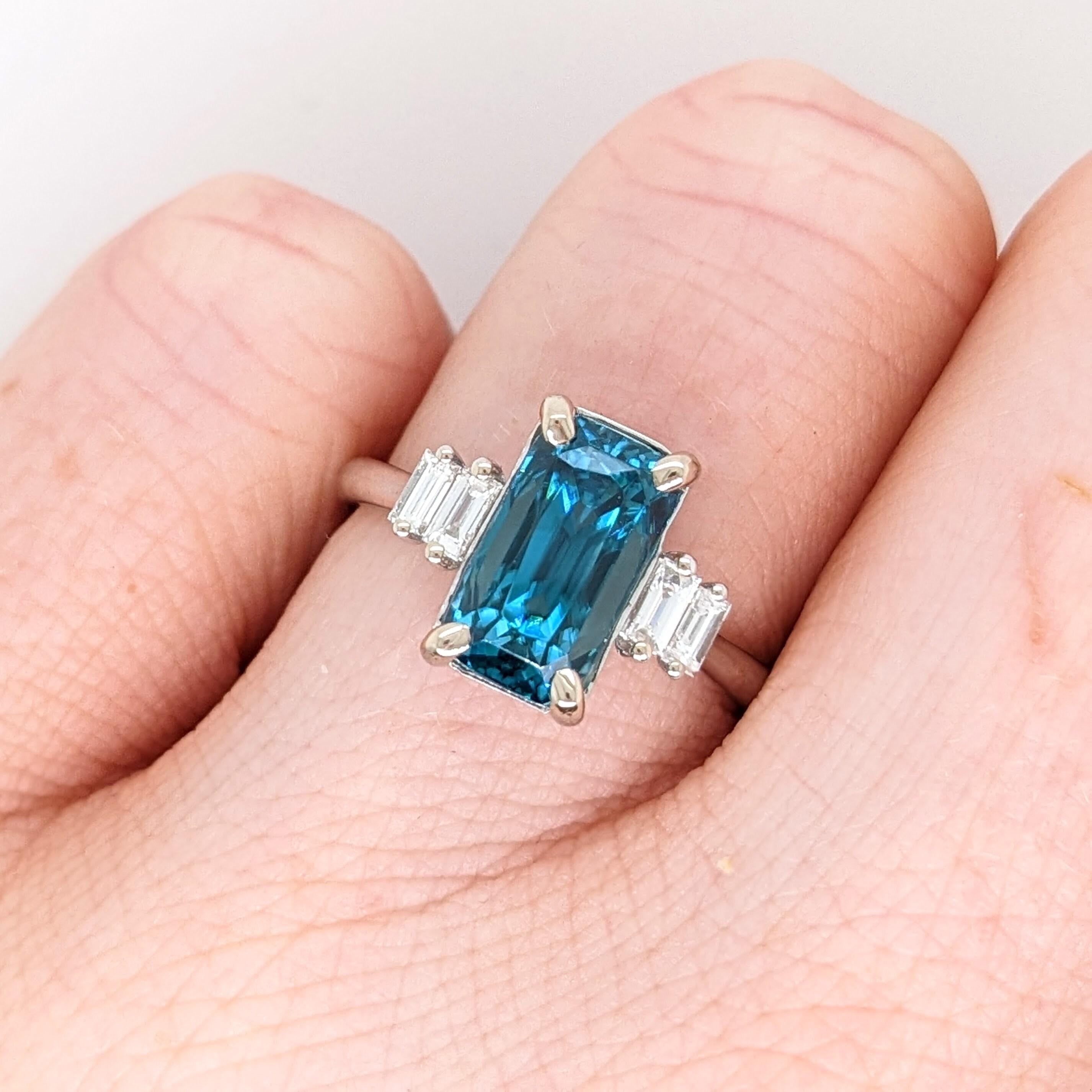 This statement ring features a gorgeous sparkling natural blue zircon in 14K solid white gold with beautiful baguette diamond accents giving it an elegant modern feel. 
Zircons are celebrated for a refractive index that comes closest to diamonds,