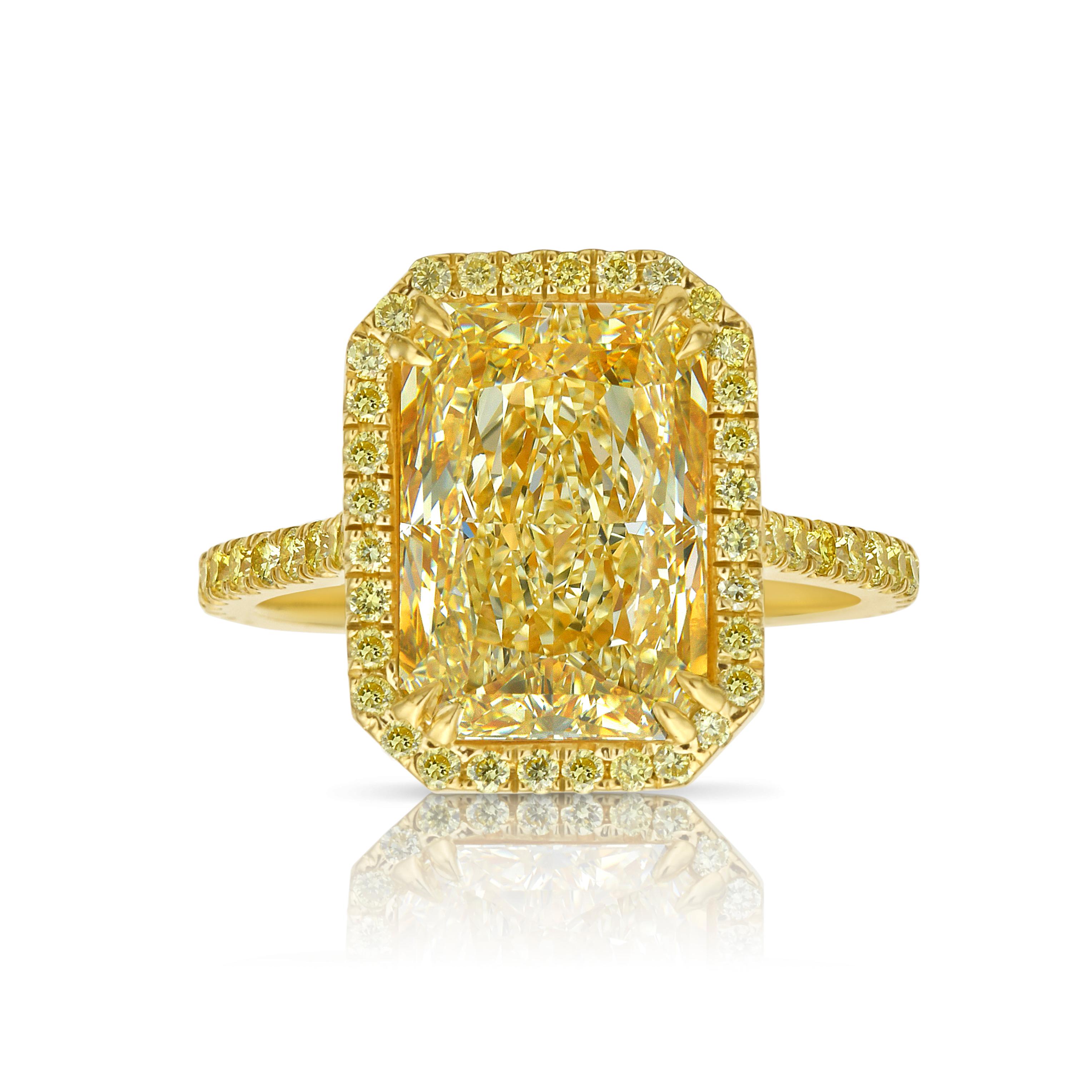 This 5-carat Light Yellow elongated radiant diamond is a brilliant example of elegance and charm. Certified as Light Yellow, its vivid glow rivals that of a Fancy Yellow diamond, radiating warmth and brilliance with every movement.

The center stone