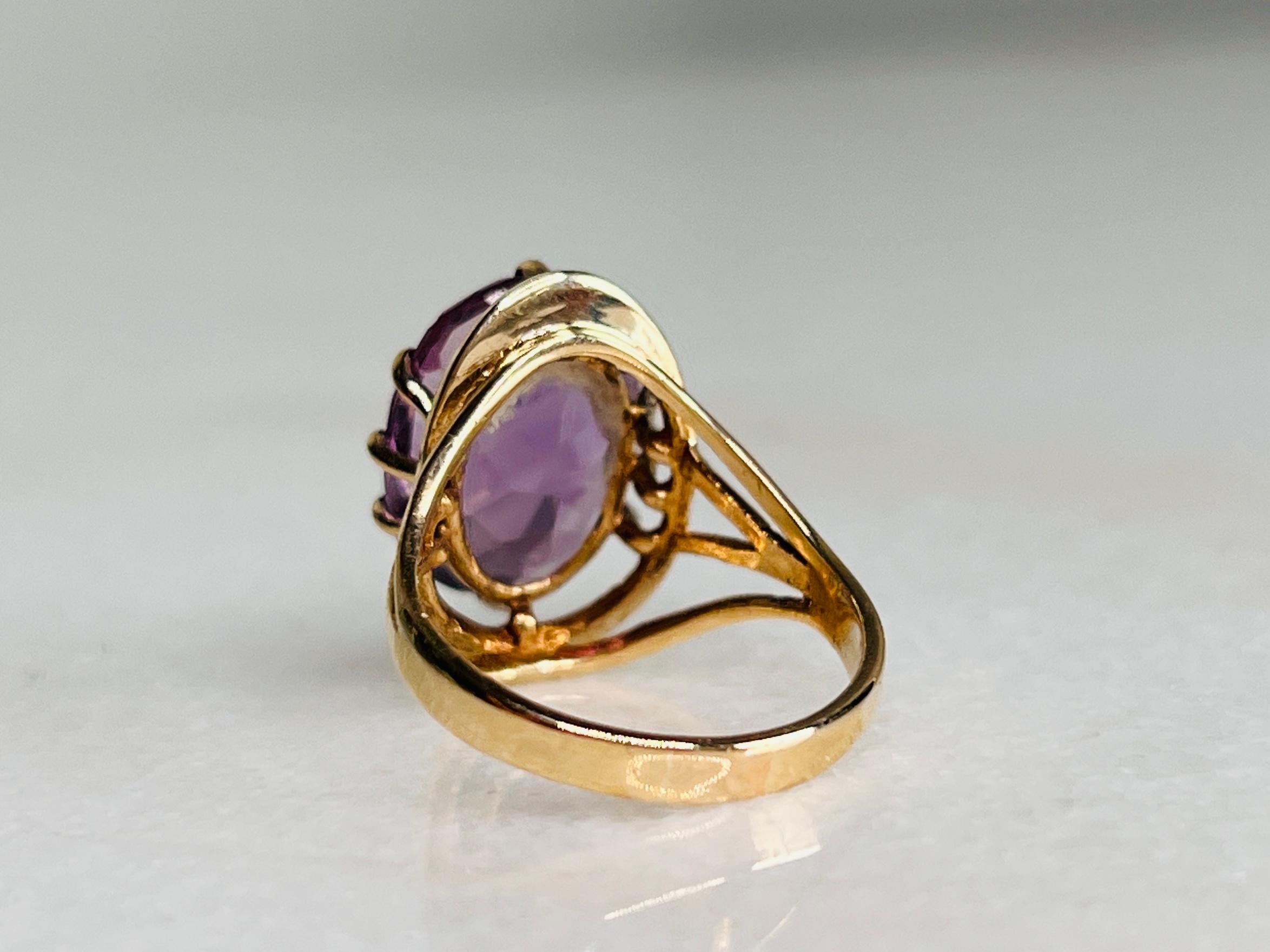 Bold yet so simple, the handmade design of this ring is masterful: the immense, oval amethyst is held by solid yellow gold in a open gallery style.

The only way to describe the stunning hue of this amethyst is that it’s like wearing a pool of
